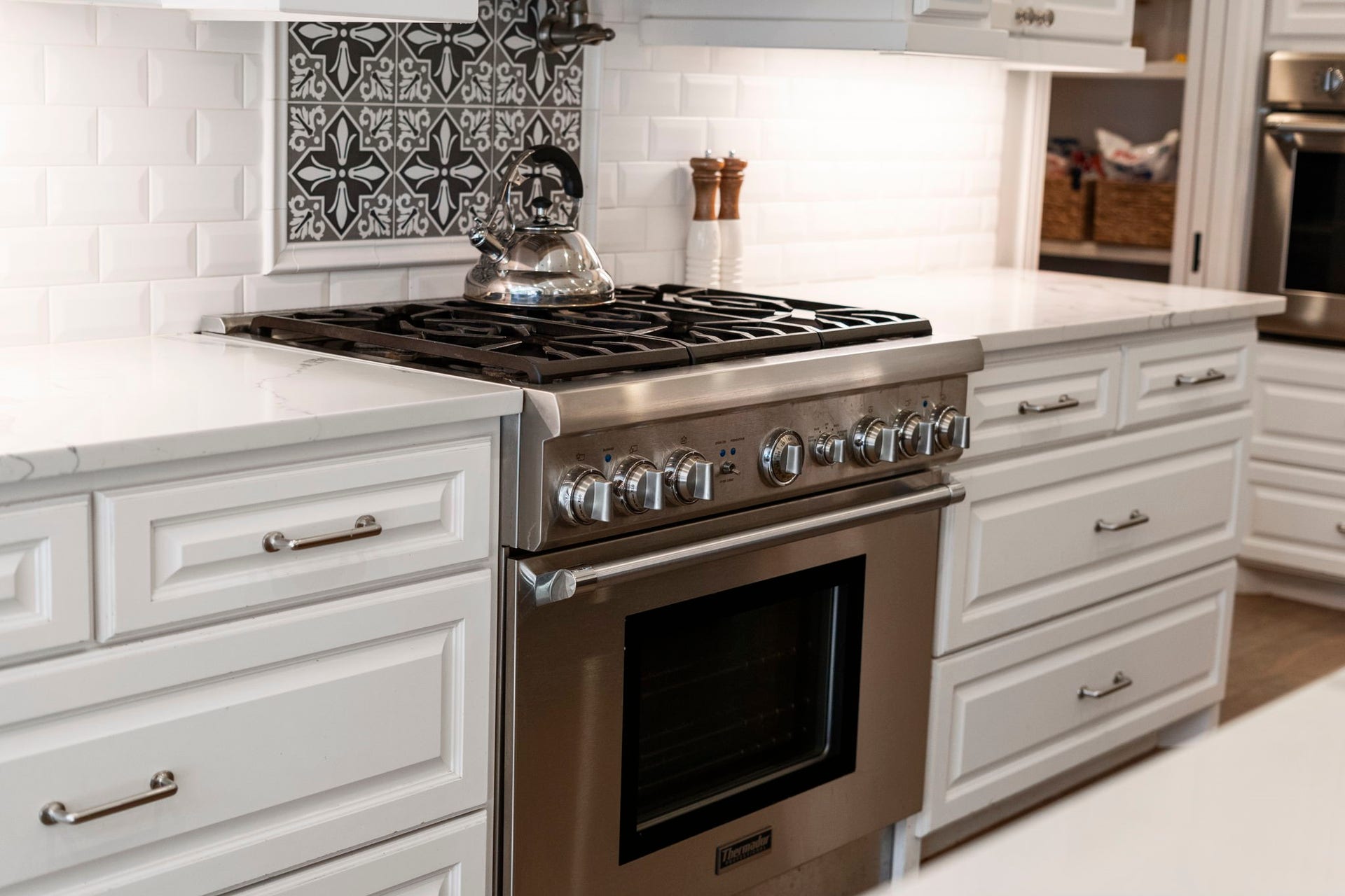 706 Oyster Creek Drive, Sugar Land, TX 77478 A Thermador six-burner gas range with convenient pot filler is complemented by an additional convection wall oven, creating an impressive cooking setup with plenty of capacity for preparing meals and hosting large family gatherings.