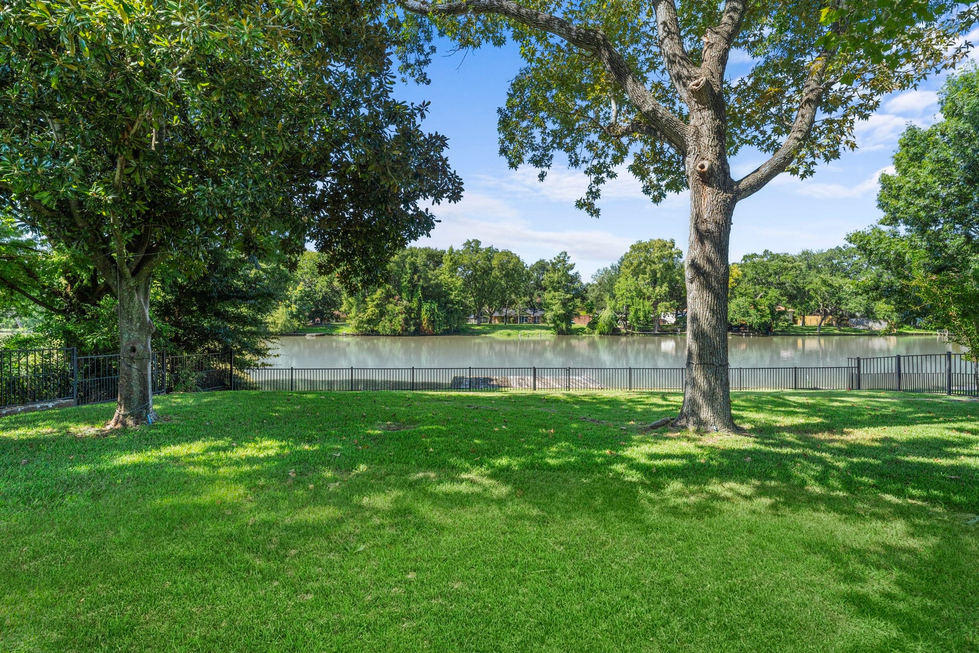 706 Oyster Creek Drive, Sugar Land, TX 77478 Mature trees, approximately 75 feet of bulkhead, and a private waterfront dock create a beautiful setting for relaxing, entertaining, and enjoying all that waterfront living has to offer.