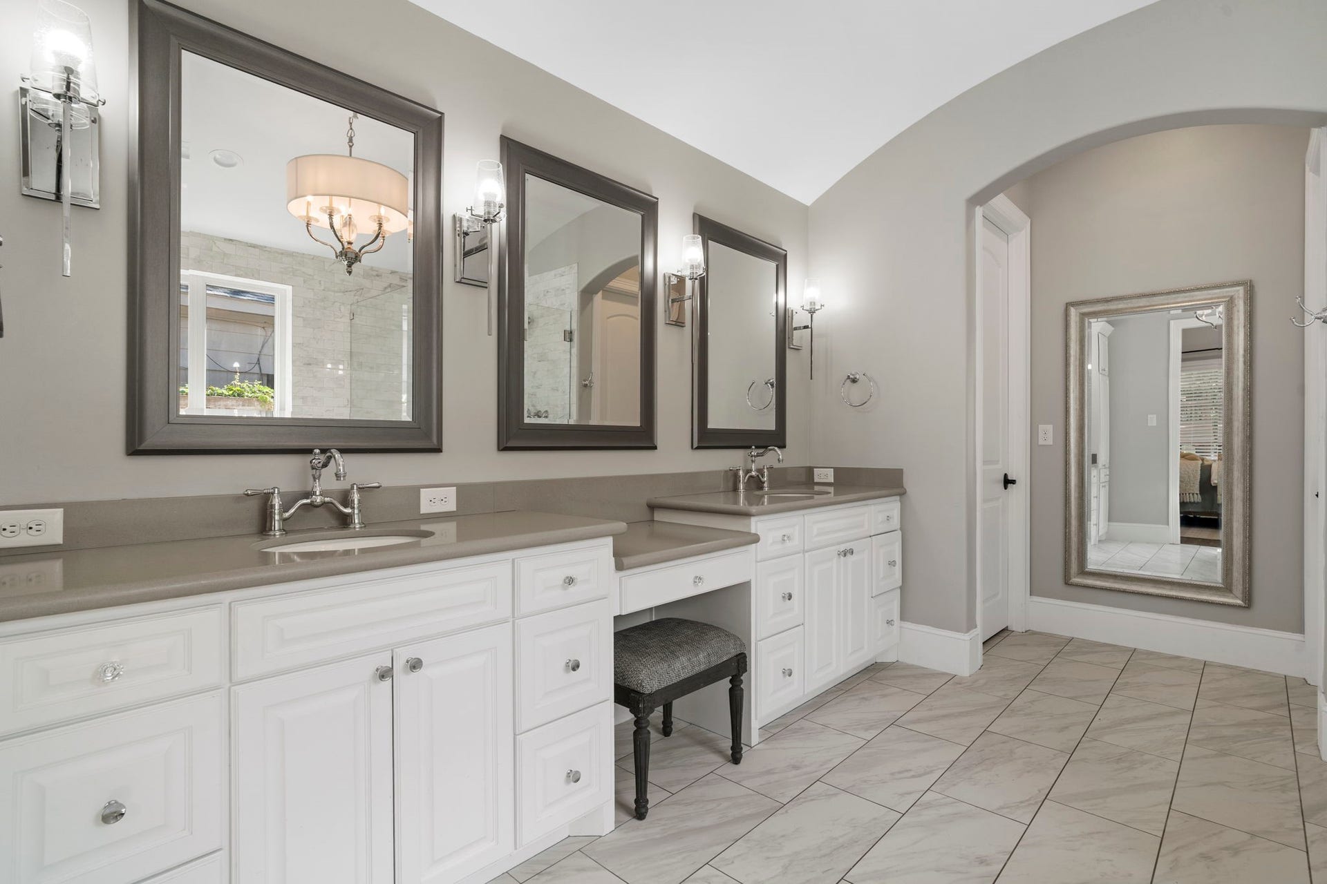706 Oyster Creek Drive, Sugar Land, TX 77478 Two separate vanities give each person their own space, while the dedicated makeup area provides a comfortable spot to get ready.