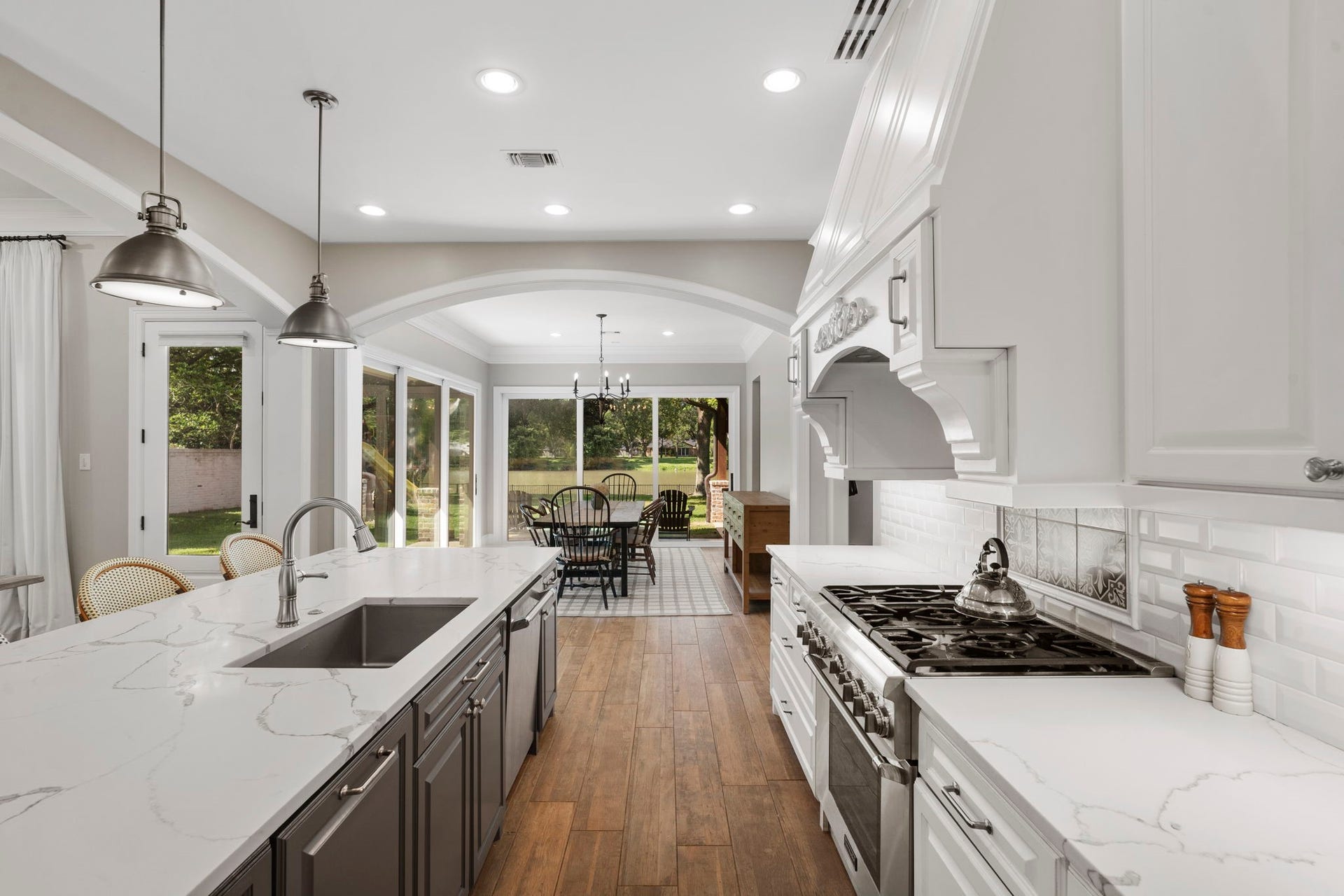 706 Oyster Creek Drive, Sugar Land, TX 77478 The gourmet kitchen is beautifully appointed with Quartz countertops and Thermador appliances including a six-burner gas range, two convection ovens, and a built-in refrigerator.