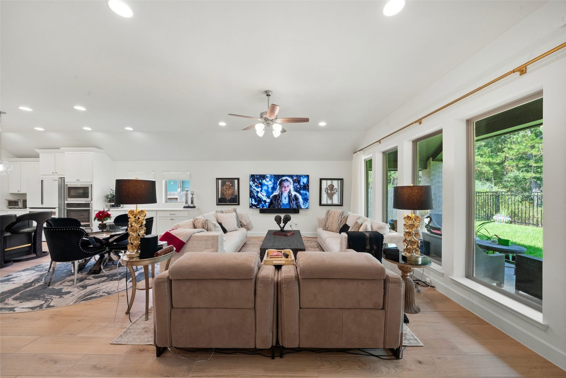 118 Sierra Stream Court, Conroe, TX 77304 Spacious family room offers an inviting gathering space with elevated ceilings, recessed lighting, and expansive windows overlooking the wooded greenbelt. The seamless connection to the kitchen and dining areas creates an ideal setting for entertaining.