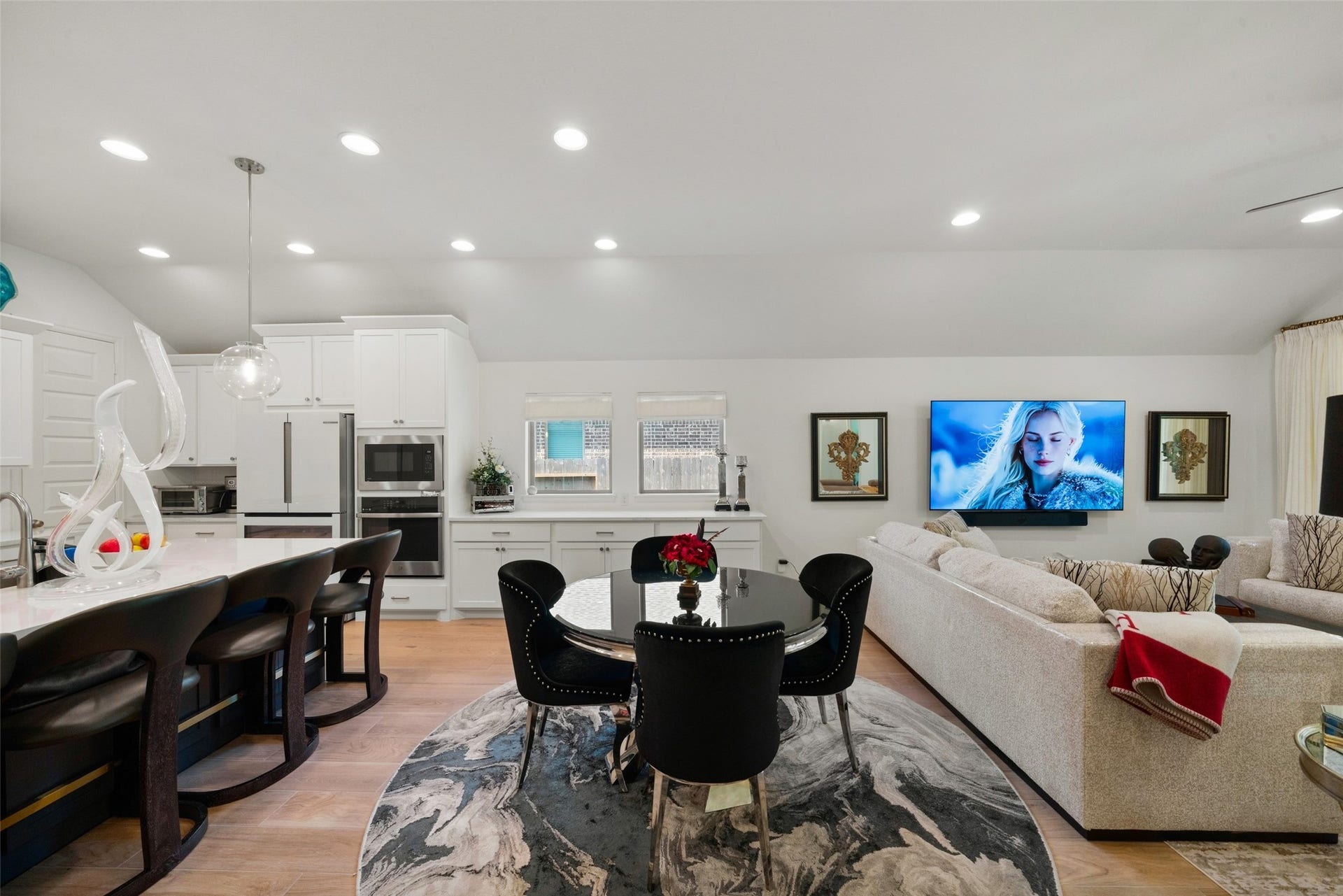 118 Sierra Stream Court, Conroe, TX 77304 Sophisticated dining area flows seamlessly into the kitchen and adjoining family room, creating a cohesive space for entertaining. Beautiful flooring, recessed lighting, and abundant natural light complement the home's thoughtfully designed layout.