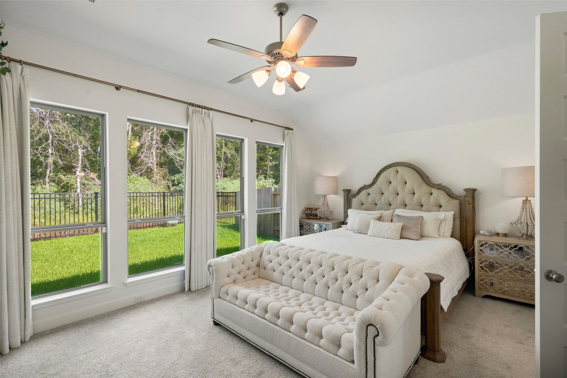 118 Sierra Stream Court, Conroe, TX 77304 Serene primary suite featuring elevated ceilings, expansive windows, and beautiful views of the lush greenbelt beyond. Abundant natural light creates a peaceful, private retreat.