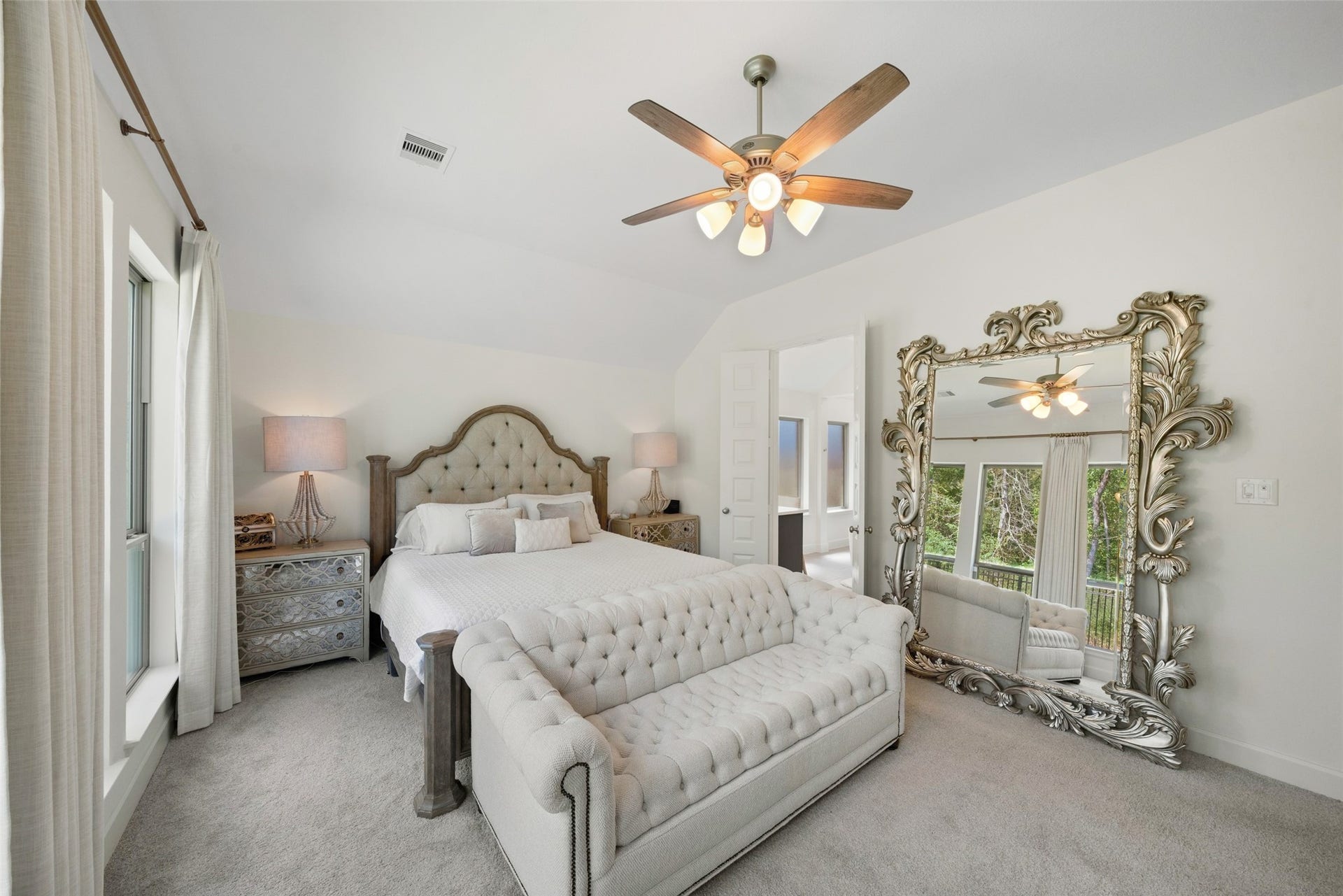 118 Sierra Stream Court, Conroe, TX 77304 Spacious primary retreat offers elevated ceilings, generous natural light, and ample room for substantial furnishings. Large windows overlooking the greenery complement the room's inviting atmosphere.