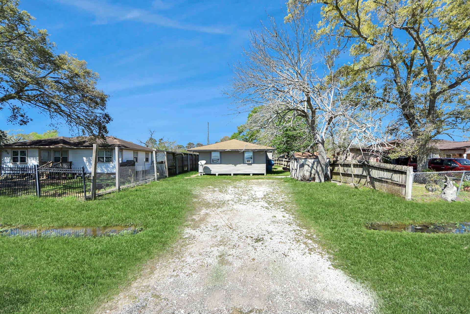 817 Church Street, Crosby, TX 77532 exterior view from the road showing the driveway leading up to the parking area