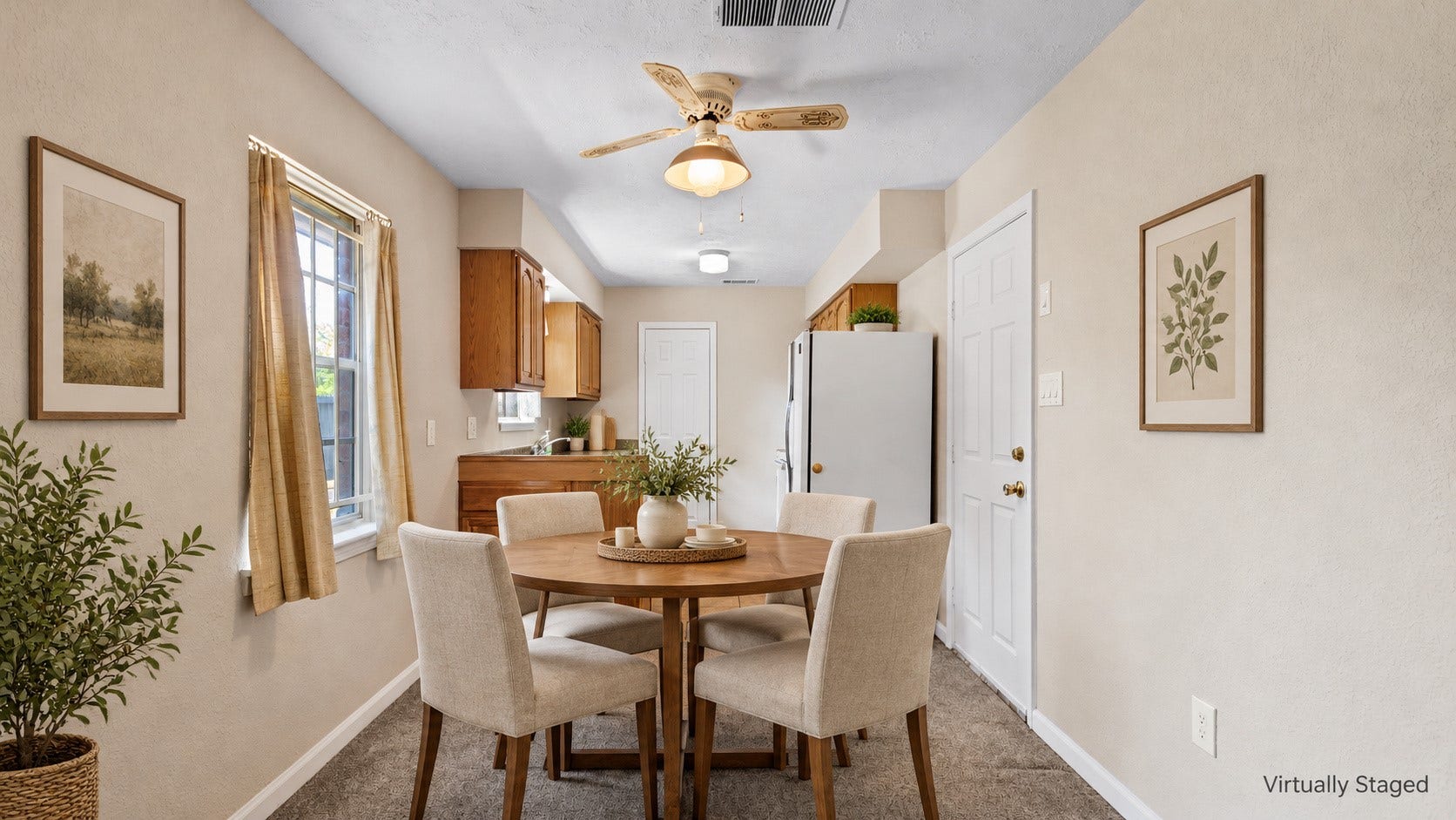 Virtually staged dining area with a round table and seating for four.