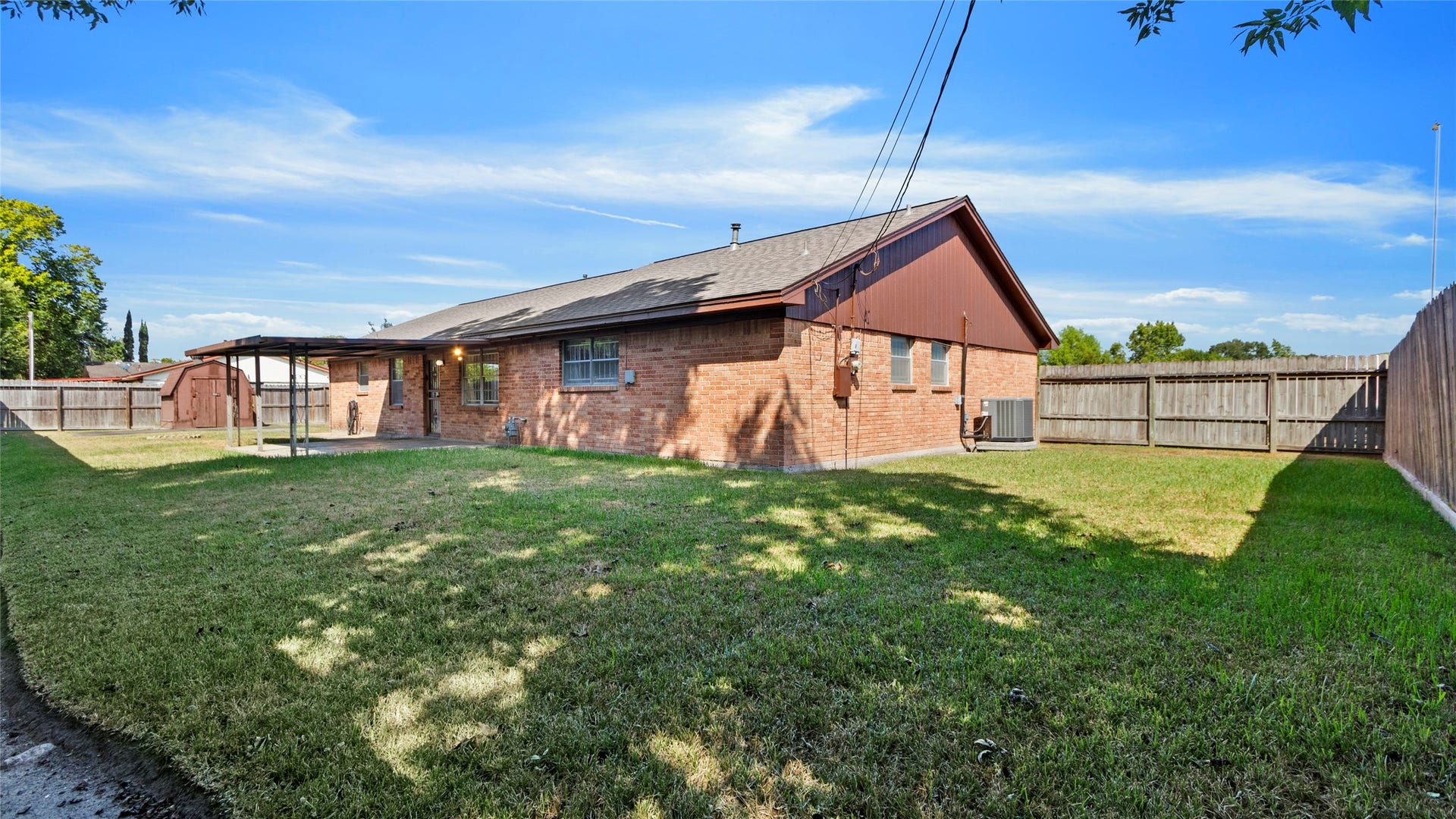 Spacious fenced backyard with room for gardening and outdoor activities.