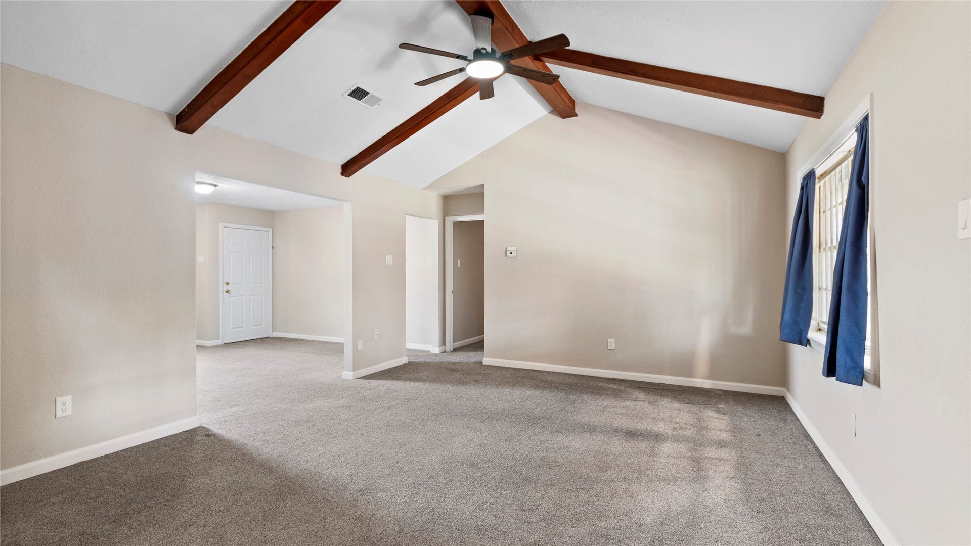 Spacious family room with a ceiling fan and room for comfortable seating.