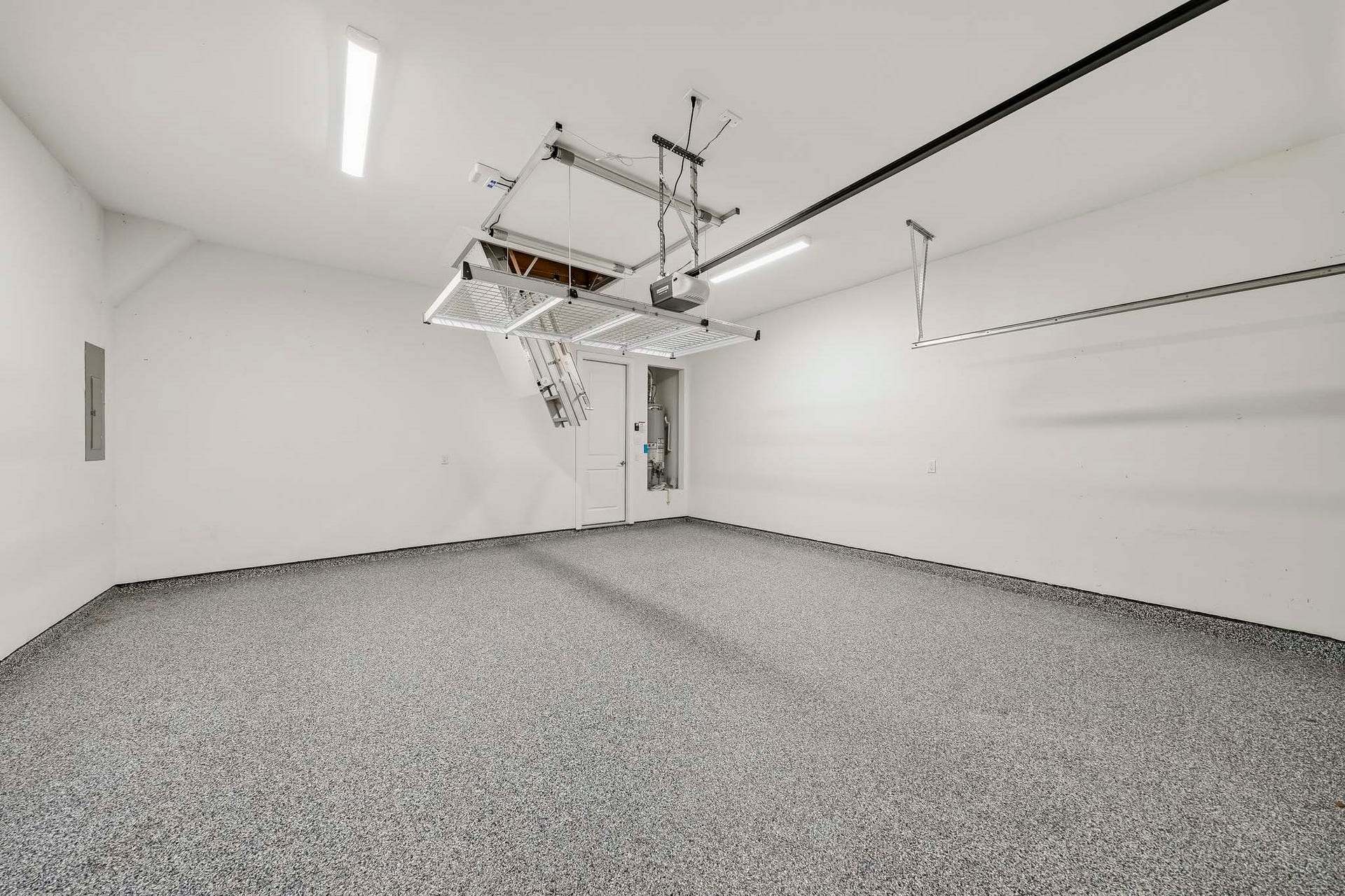 9527 Waxwing Trace, Manvel, TX 77578 Garage floor is epoxied. Remote control aluminum stairs to attic and remote control storage lift.