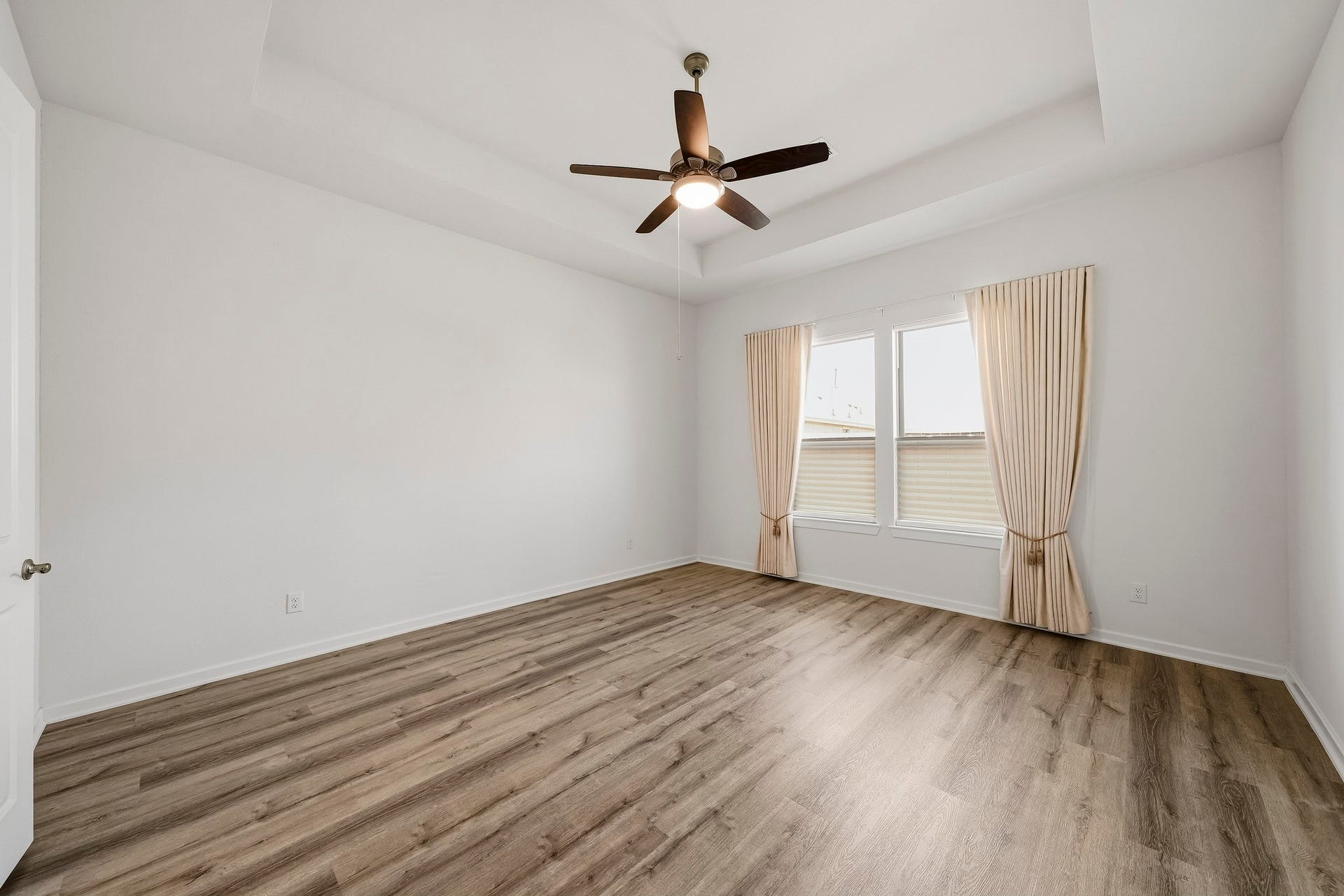 9527 Waxwing Trace, Manvel, TX 77578 Primary bedroom has custom draperies and bottom-up/top-down shades.