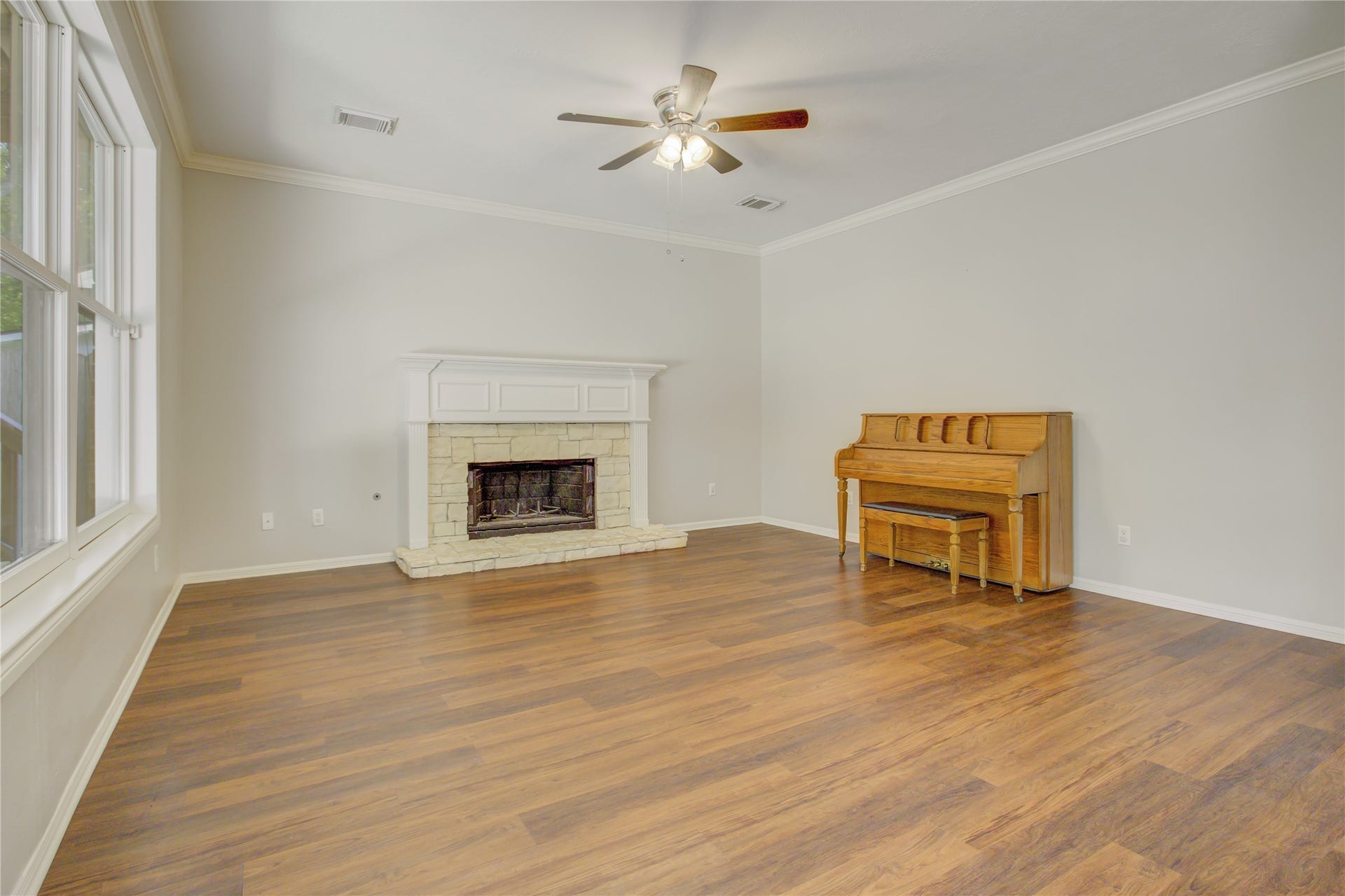 2826 Spring Lakes, Missouri City, TX 77459 Curl up by the stone fireplace on cool evenings while the generous windows bring in peaceful natural light.