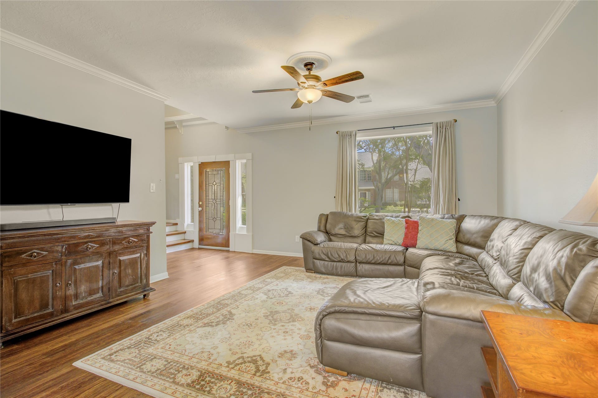 2826 Spring Lakes, Missouri City, TX 77459 Big front windows fill the living room with natural light, and crown molding adds a tailored finish.