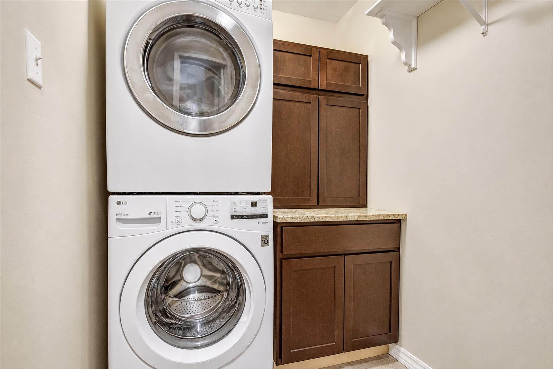 2826 Spring Lakes, Missouri City, TX 77459 A laundry room with cabinet storage and a granite folding counter makes laundry day a little easier.