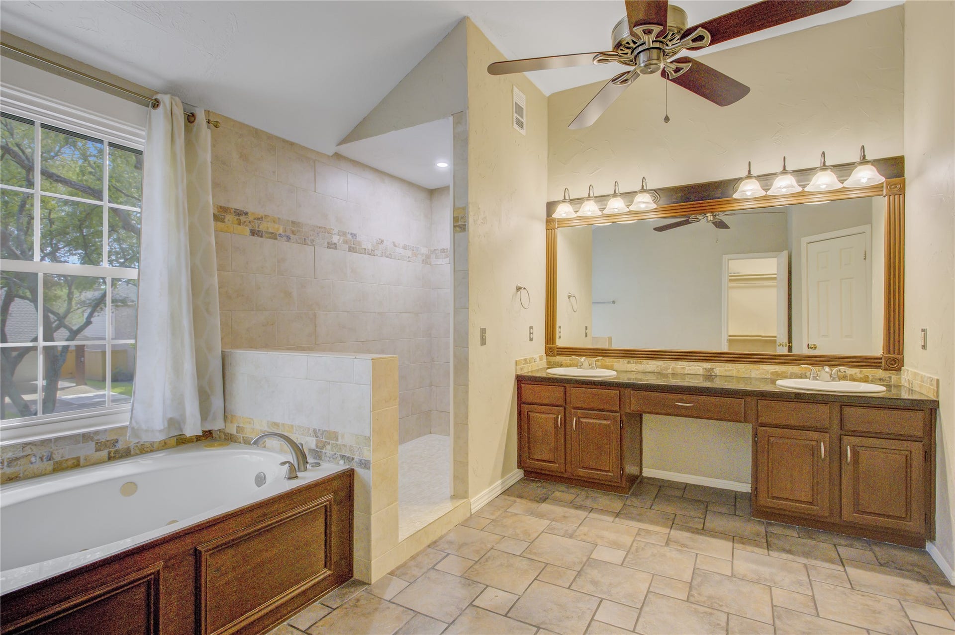 2826 Spring Lakes, Missouri City, TX 77459 The primary bath is made for slow mornings, with a double vanity, a makeup area, a soaking tub and a walk-in shower.