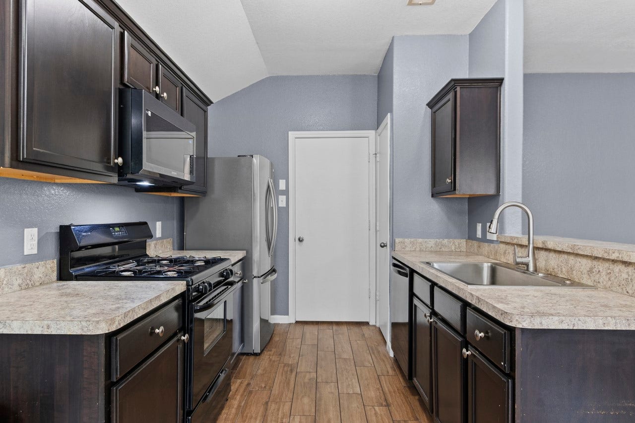 683 Fallow Lane, Alvin, TX 77511 Kitchen with Full Pantry. Door goes to Laundry Room then into Garage