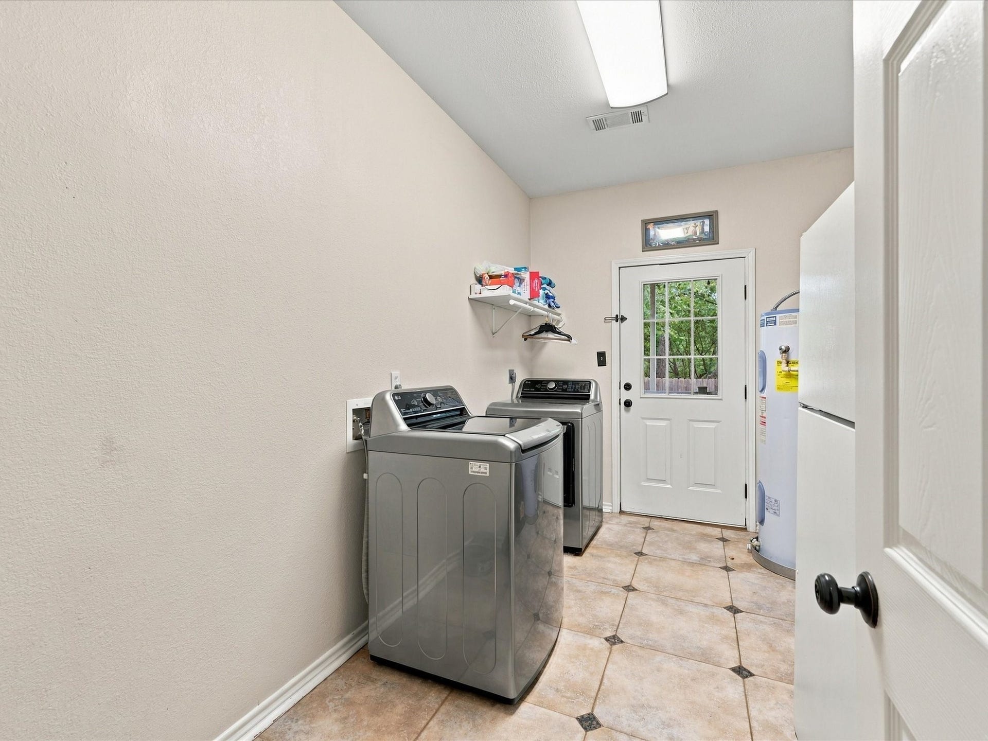 306 Sherwood Forest Street, Conroe, TX 77316 The dedicated utility room provides convenient space for laundry and household essentials.