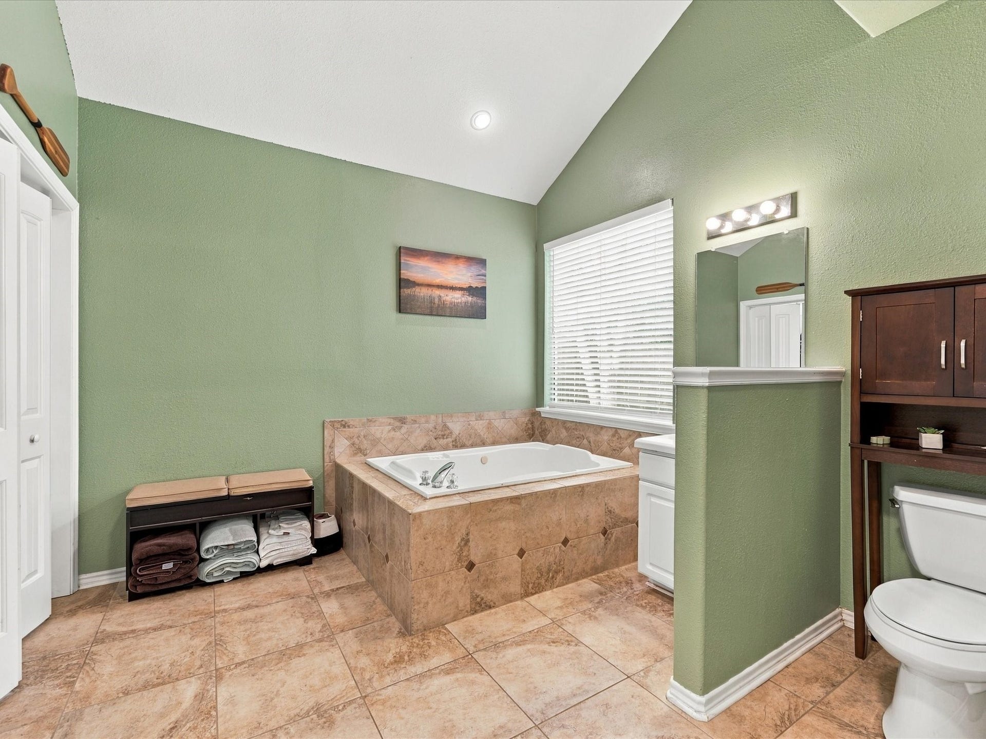 306 Sherwood Forest Street, Conroe, TX 77316 The primary ensuite offers plenty of space with a jetted tub, spacious shower & large walk-in closet.