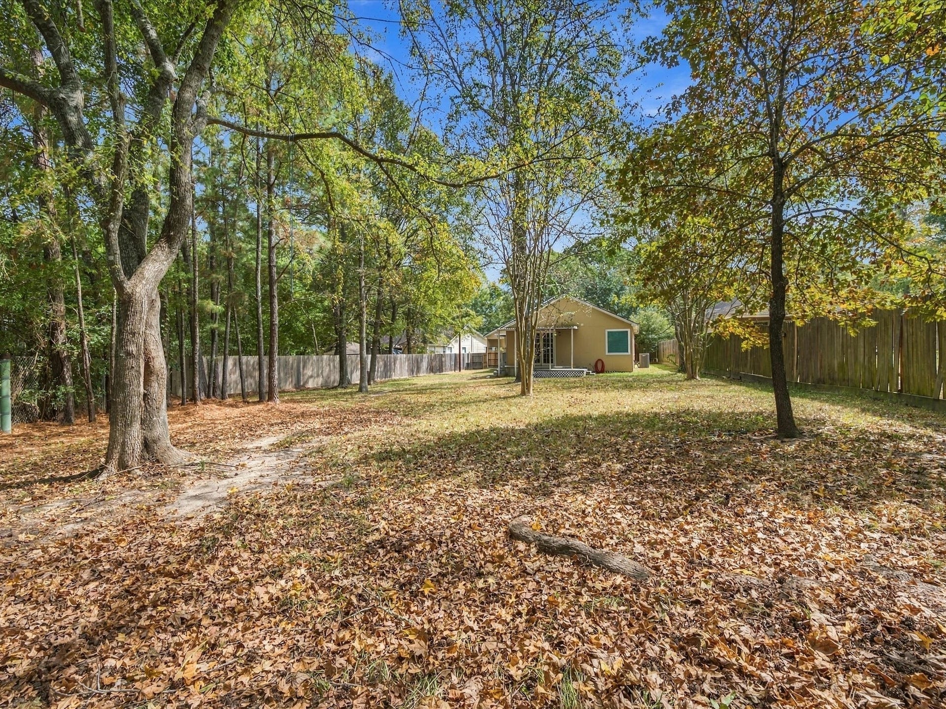 306 Sherwood Forest Street, Conroe, TX 77316 Mature trees add character to the expansive backyard and enhance the home's quiet, established setting.