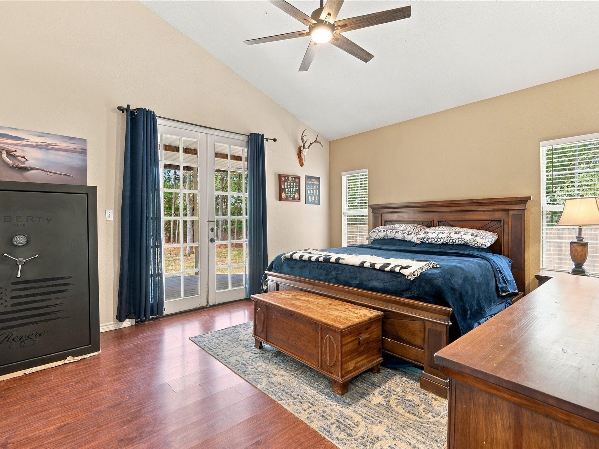 306 Sherwood Forest Street, Conroe, TX 77316 The expansive primary bedroom features vaulted ceilings & private access to the back porch for an easy connection to the outdoors.