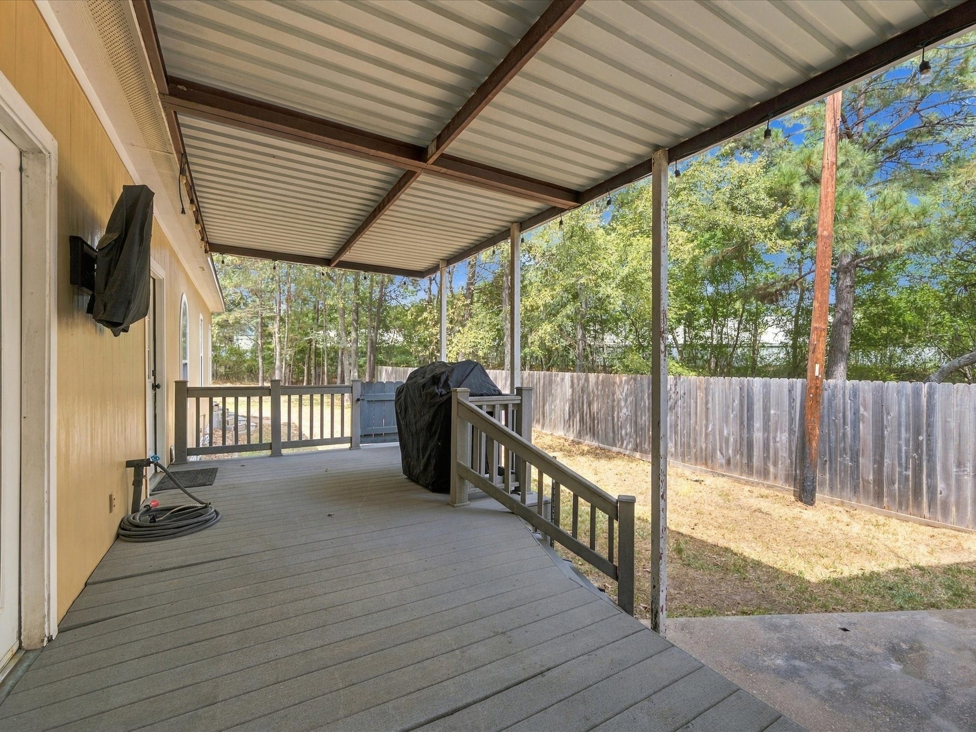 306 Sherwood Forest Street, Conroe, TX 77316 A spacious back porch overlooks the expansive backyard, offering room to relax, dine outdoors or enjoy the surrounding setting. Also, bedroom creates another inviting outdoor space overlooking the backyard.