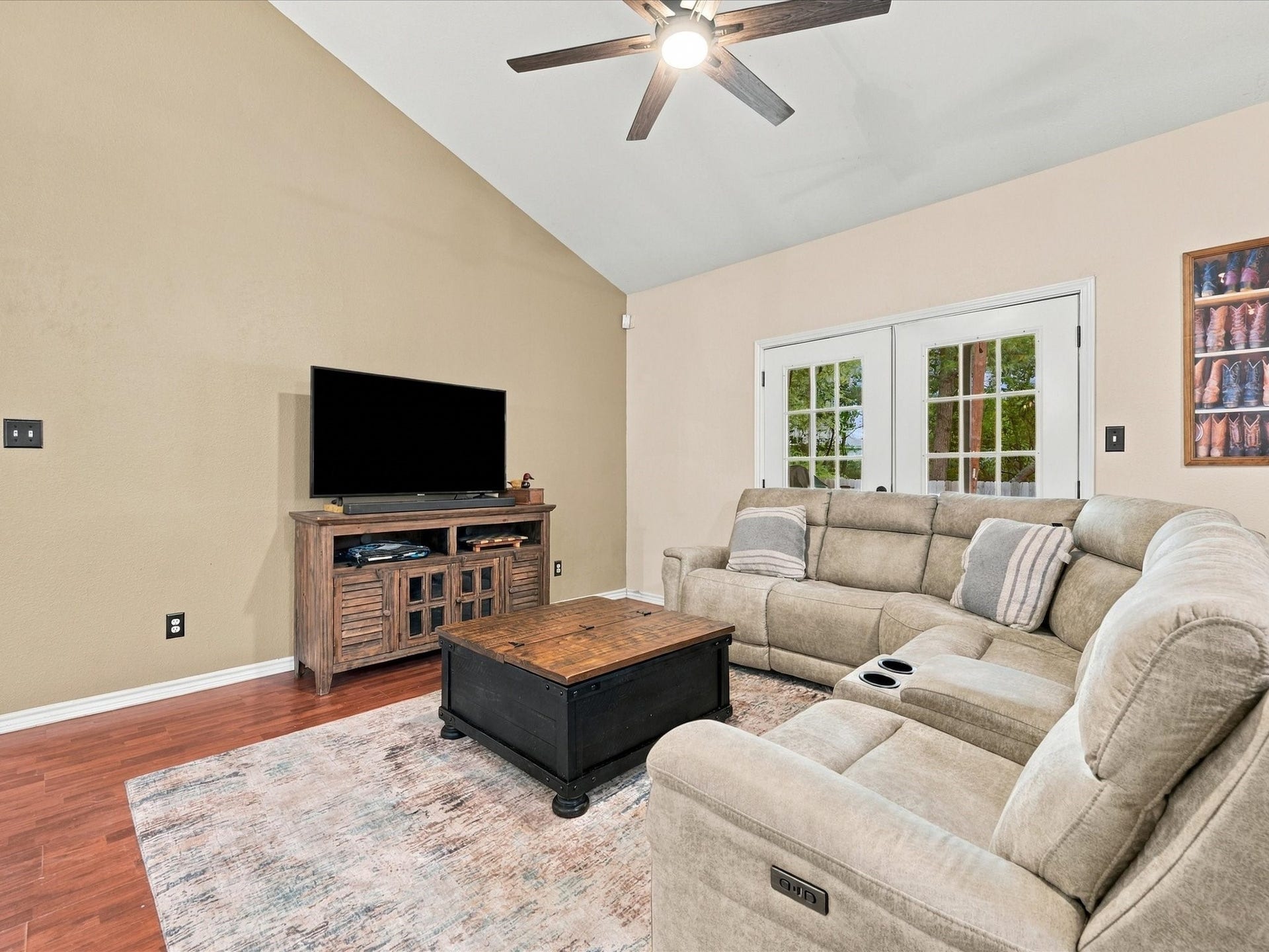 306 Sherwood Forest Street, Conroe, TX 77316 The spacious living room features vaulted ceilings & French doors that open to the back porch, bringing in natural light and extending the living space outdoors.