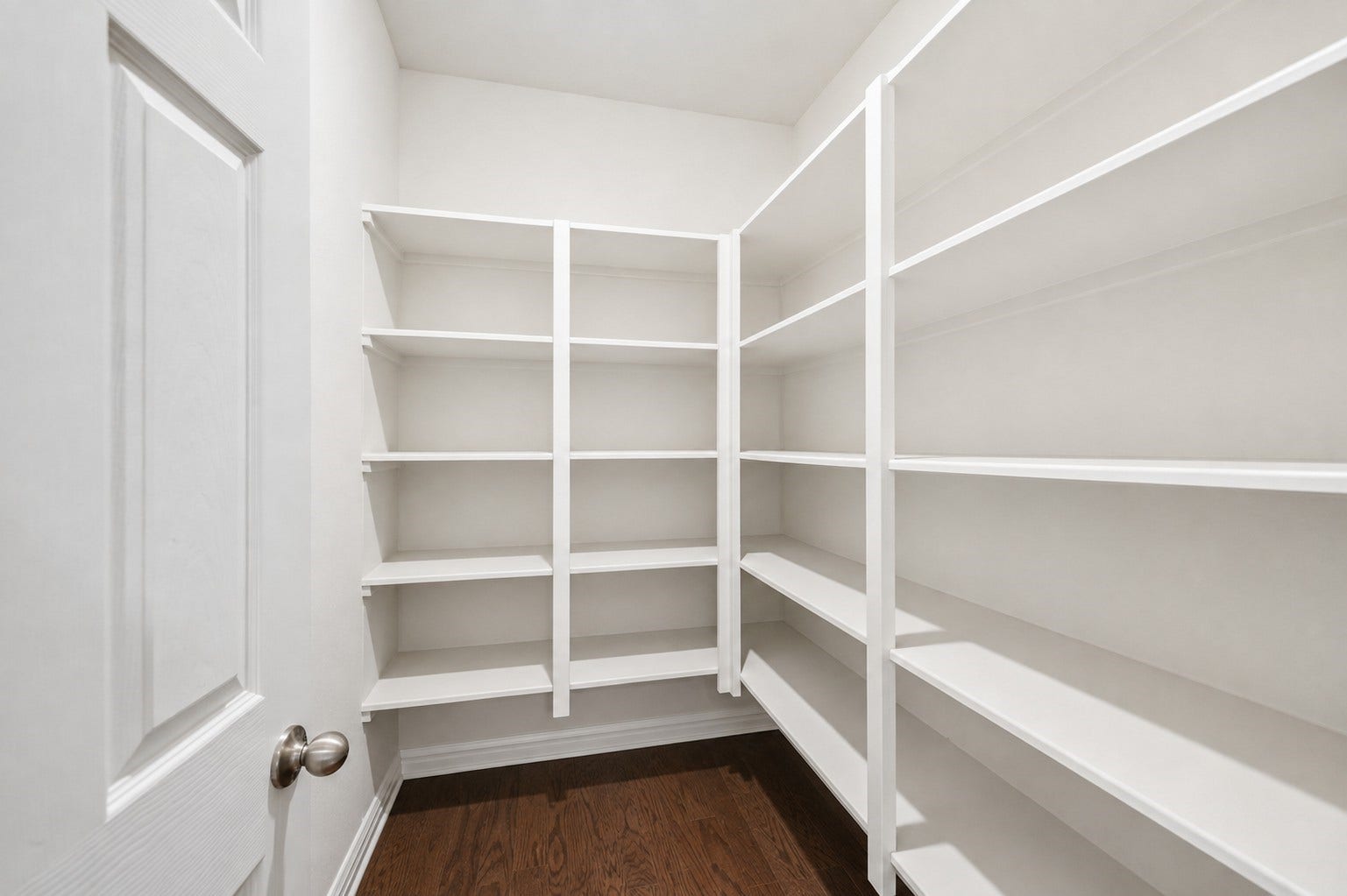 Virtually Cleaned: This spacious walk-in pantry offers exceptional storage with extensive built-in shelving wrapping around the space. Multiple tiers provide plenty of room for groceries, small appliances, cookware, and household essentials, helping keep the kitchen organized and clutter-free. The generous size and easy-access layout make it ideal for everyday storage and stocking up on pantry staples.