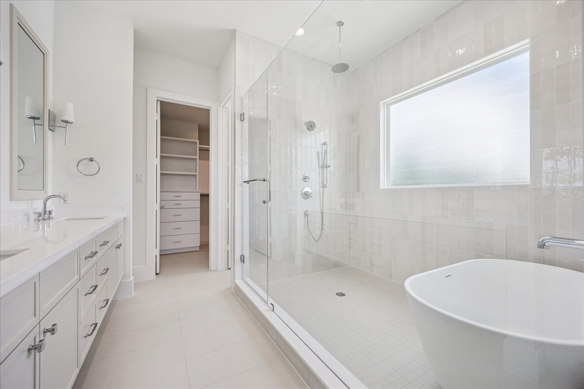 310 Fowler Street, Houston, TX 77007 Spa-inspired primary bath with freestanding soaking tub, oversized shower and designer finishes.