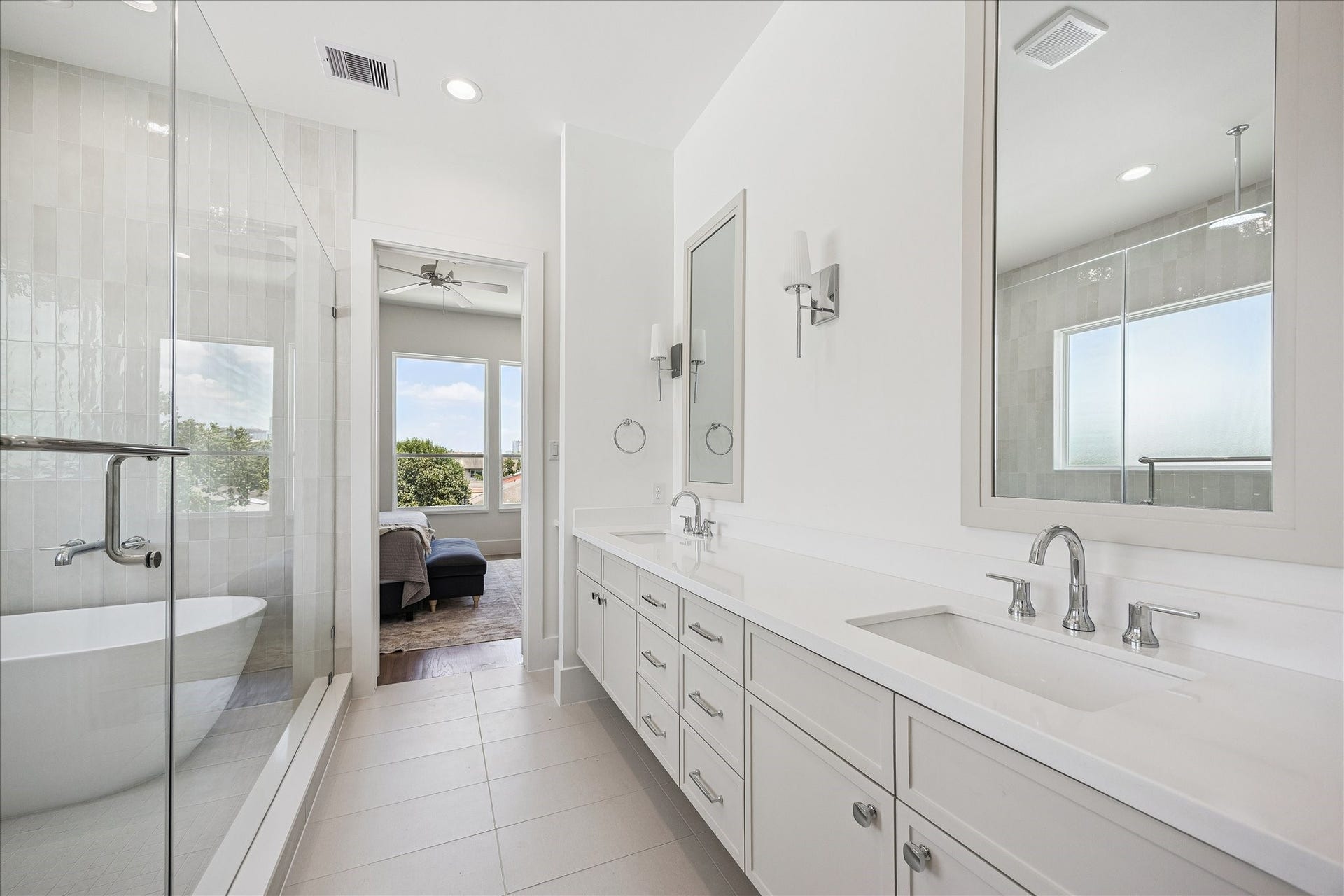310 Fowler Street, Houston, TX 77007 Spa-inspired primary bath with freestanding soaking tub, oversized shower and designer finishes.