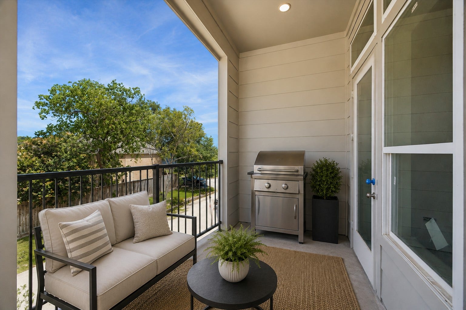 310 Fowler Street, Houston, TX 77007 Covered terrace complete with outdoor grilling area and cozy seatingperfect for entertaining year-round. A digitally staged image.