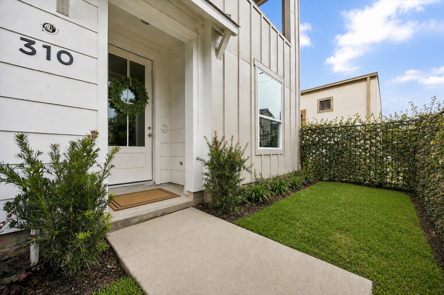 310 Fowler Street, Houston, TX 77007 Alternate view of private fenced front yard with lush green spaceperfect for pets, grilling or kids play. Mature privacy greenery digitally enhanced.