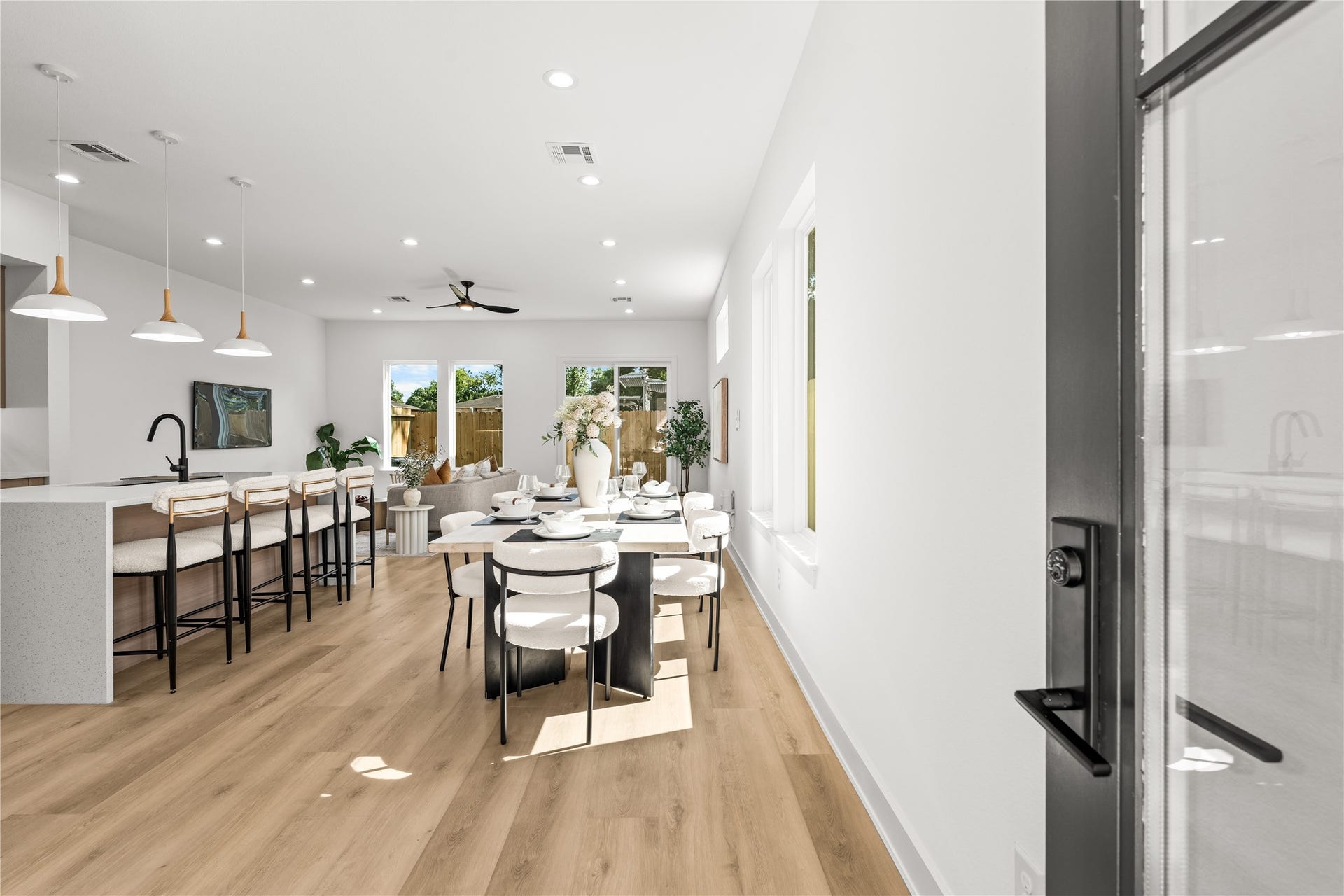 3012 & 3014 Beulah St, Houston, TX 77004 Inside, the open layout immediately feels spacious and bright, with light flooring connecting the living and dining areas. The kitchen features a large island with a white quartz waterfall countertop, making it a natural setup for quick meals or casual hanging out.