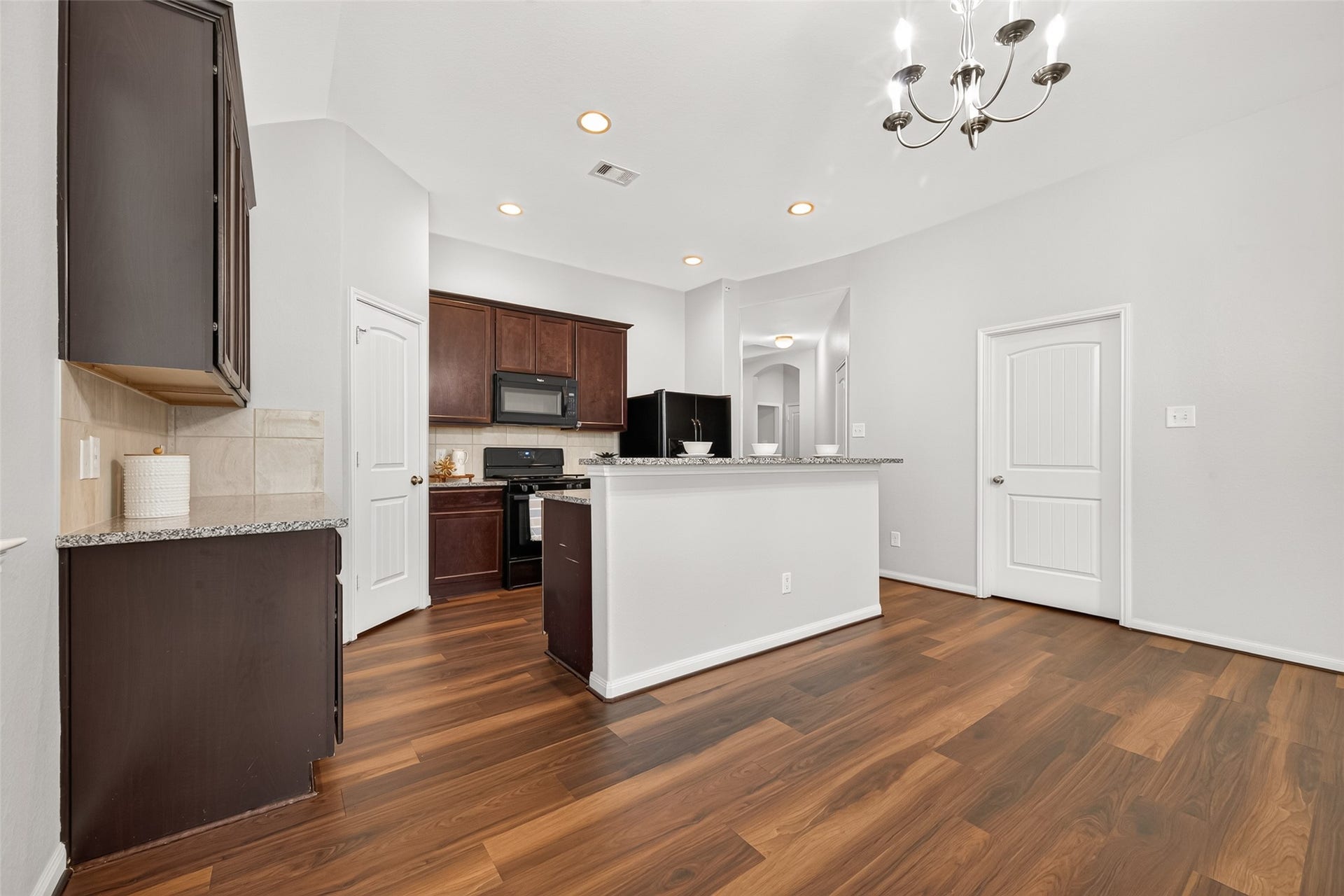 1018 Pleasant Bend, Conroe, TX 77301 The Kitchen features beautiful granite countertops and a coordinating tile backsplash for a clean, classic look.