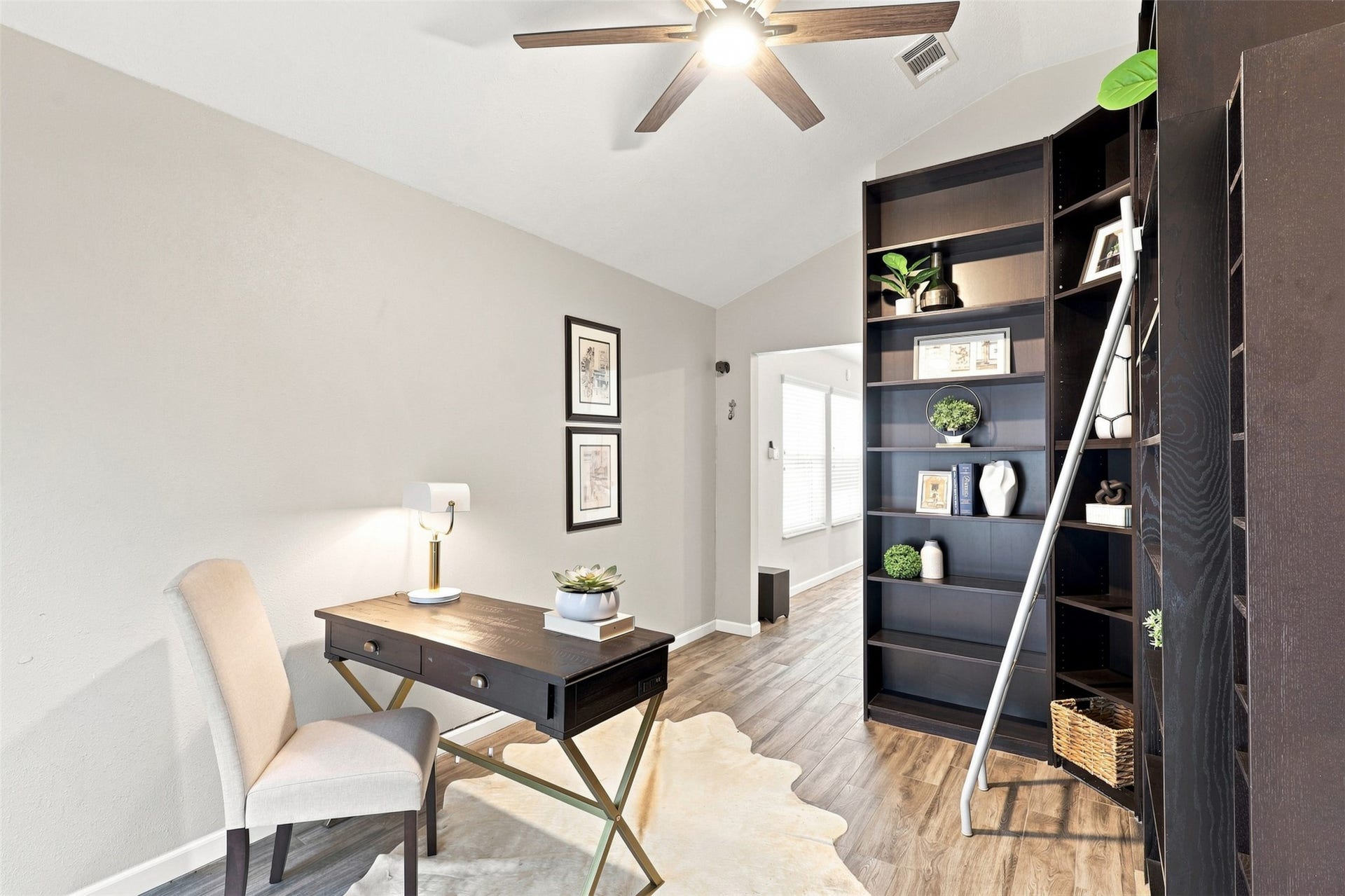 Alternate view of the flexible home office showcases vaulted ceilings and ample room for shelving, storage, and a dedicated workspace.