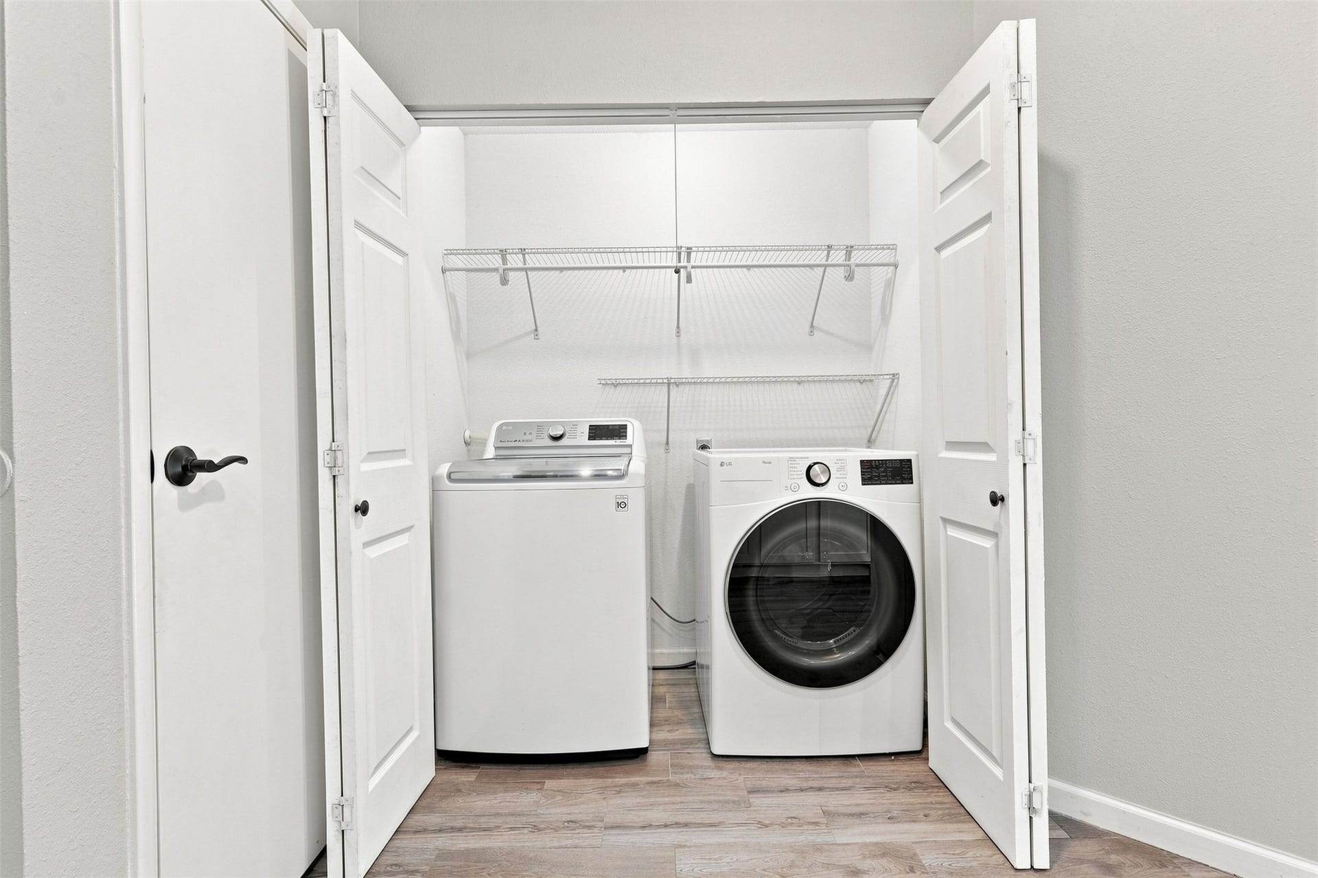 Convenient in-home laundry area features built-in shelving for added storage and organization.