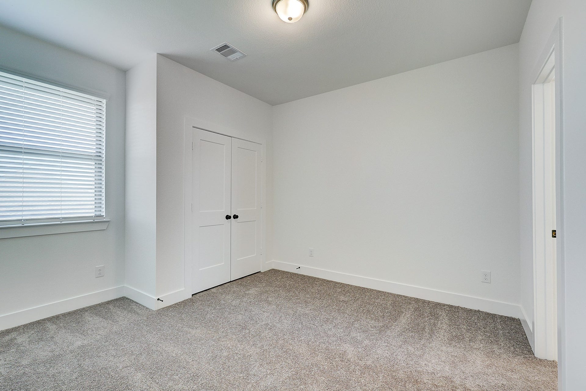 Spacious upstairs bedroom 3 with closet storage.