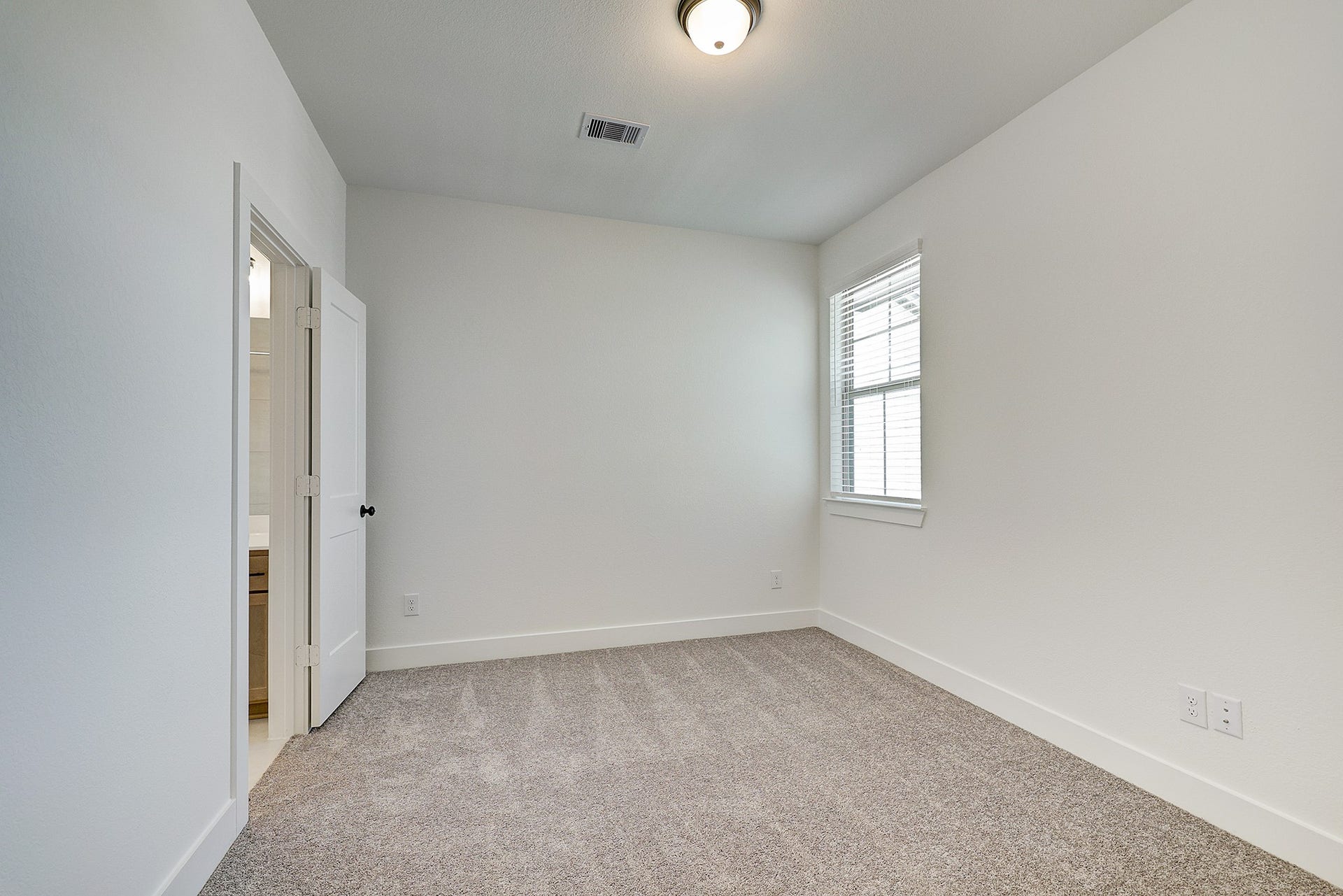 Generously sized bedroom with natural light.
