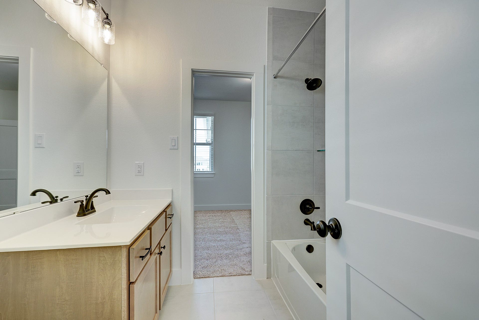 Secondary bath with tub/shower combination and vanity storage