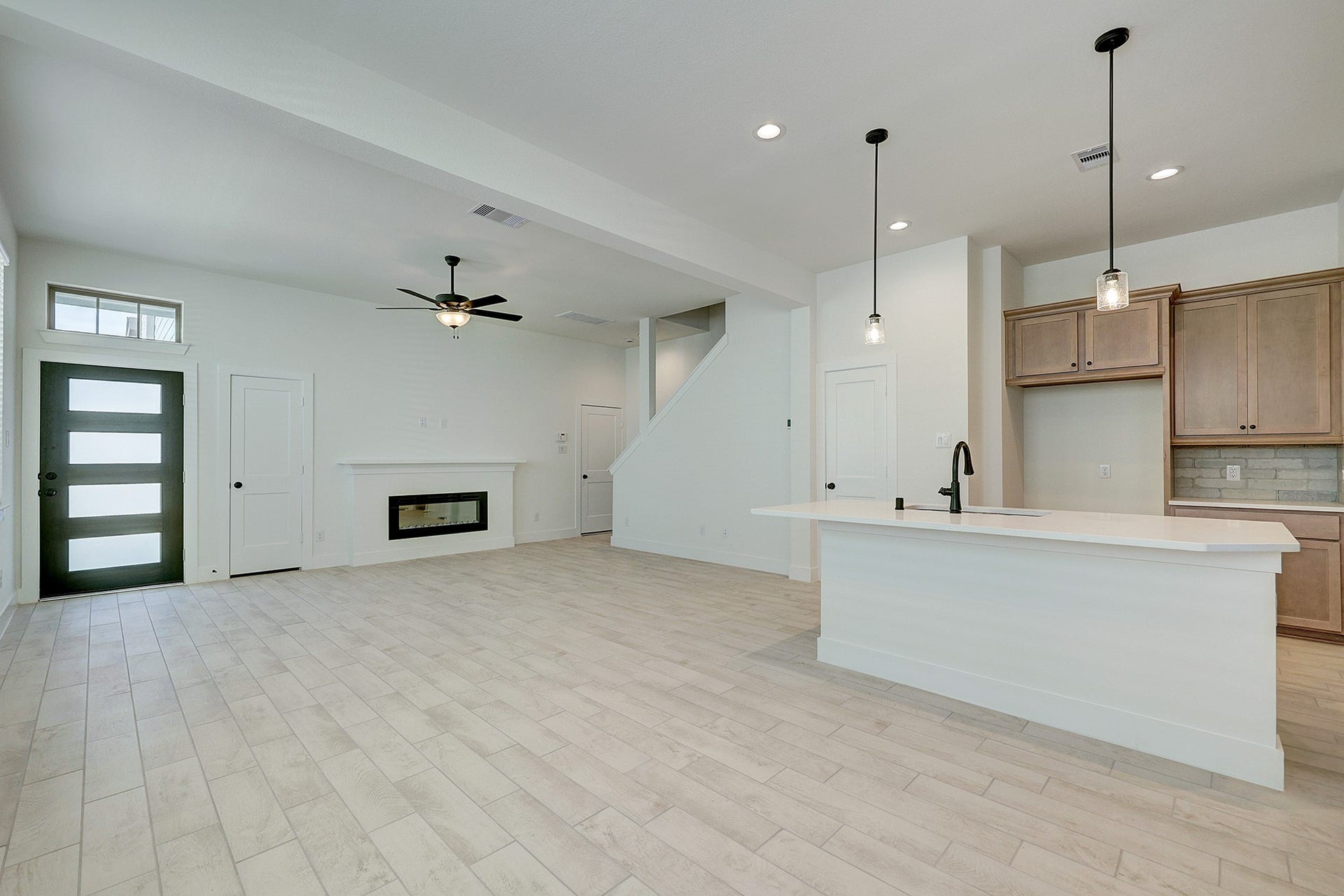 Modern open-concept design with kitchen at the heart of the home.