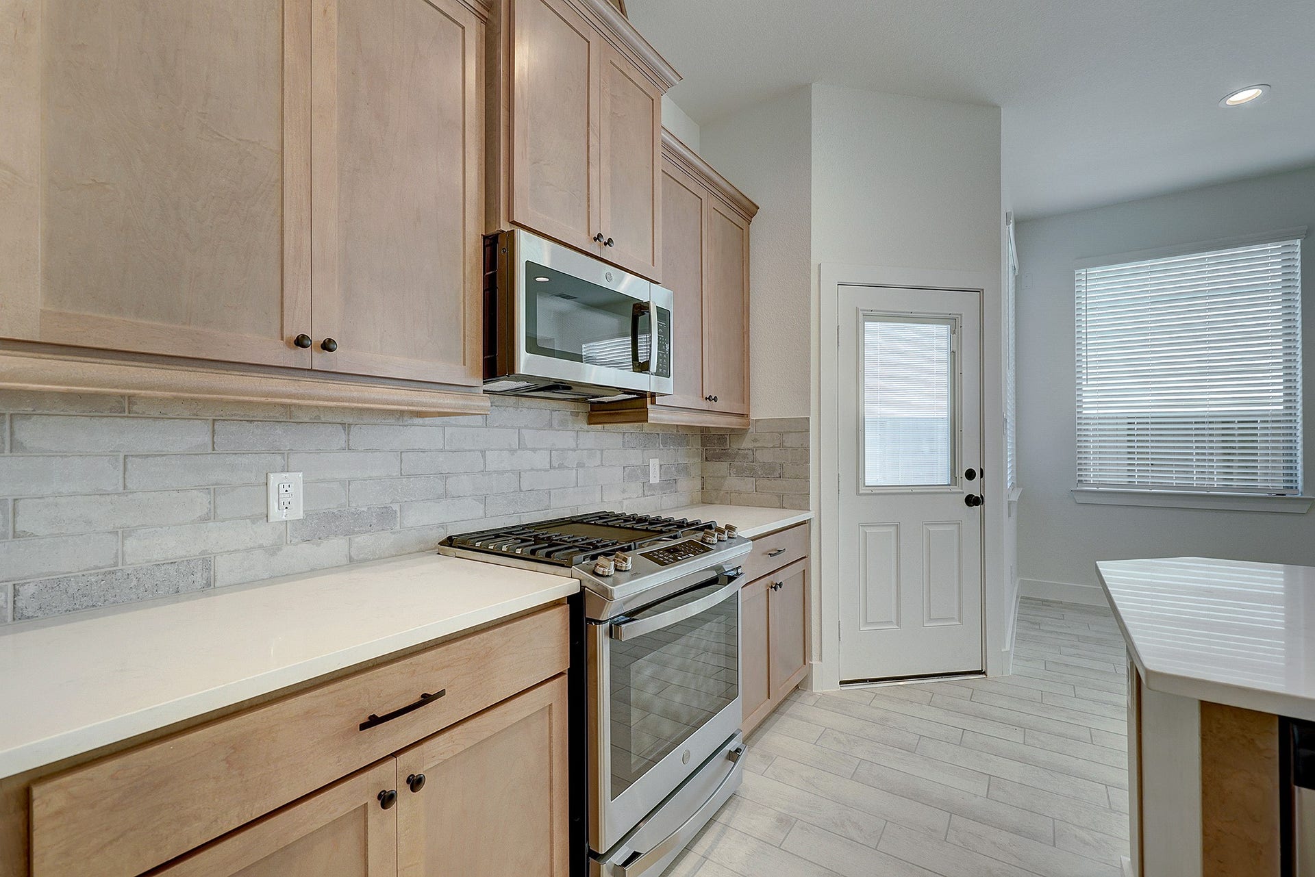 Stylish backsplash, stainless appliances and generous counter space.