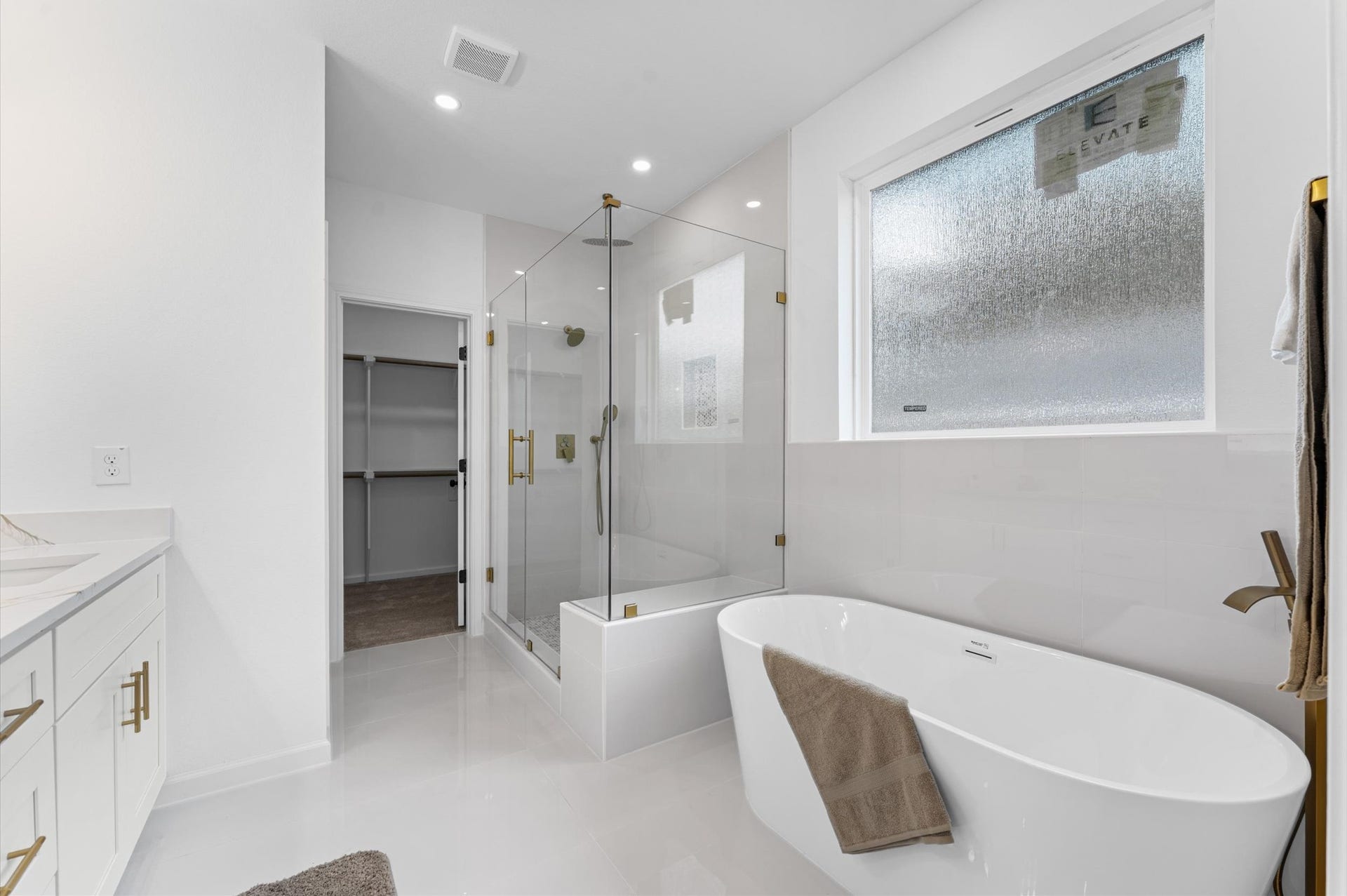 8132 Sunnyhill Street, Houston, TX 77088 Primary Bath Soaking Tub: Indulge in a spa-inspired primary ensuite featuring a luxurious freestanding soaking tub and separate walk-in shower, creating the perfect setting for relaxation