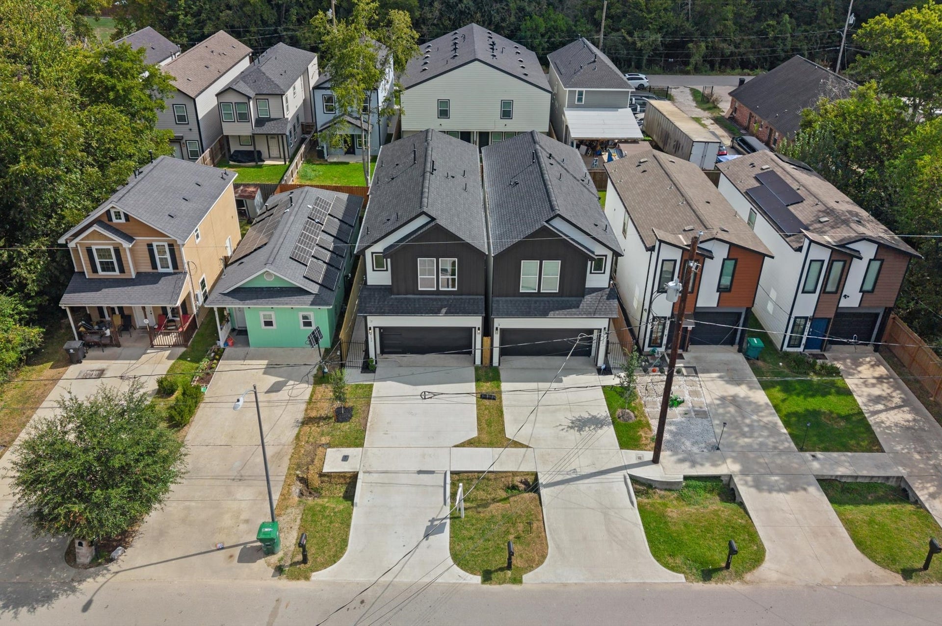 8132 Sunnyhill Street, Houston, TX 77088 Aerial Front View: A stunning birds-eye perspective of this beautifully designed new construction home, showcasing its modern architecture and curb appeal.