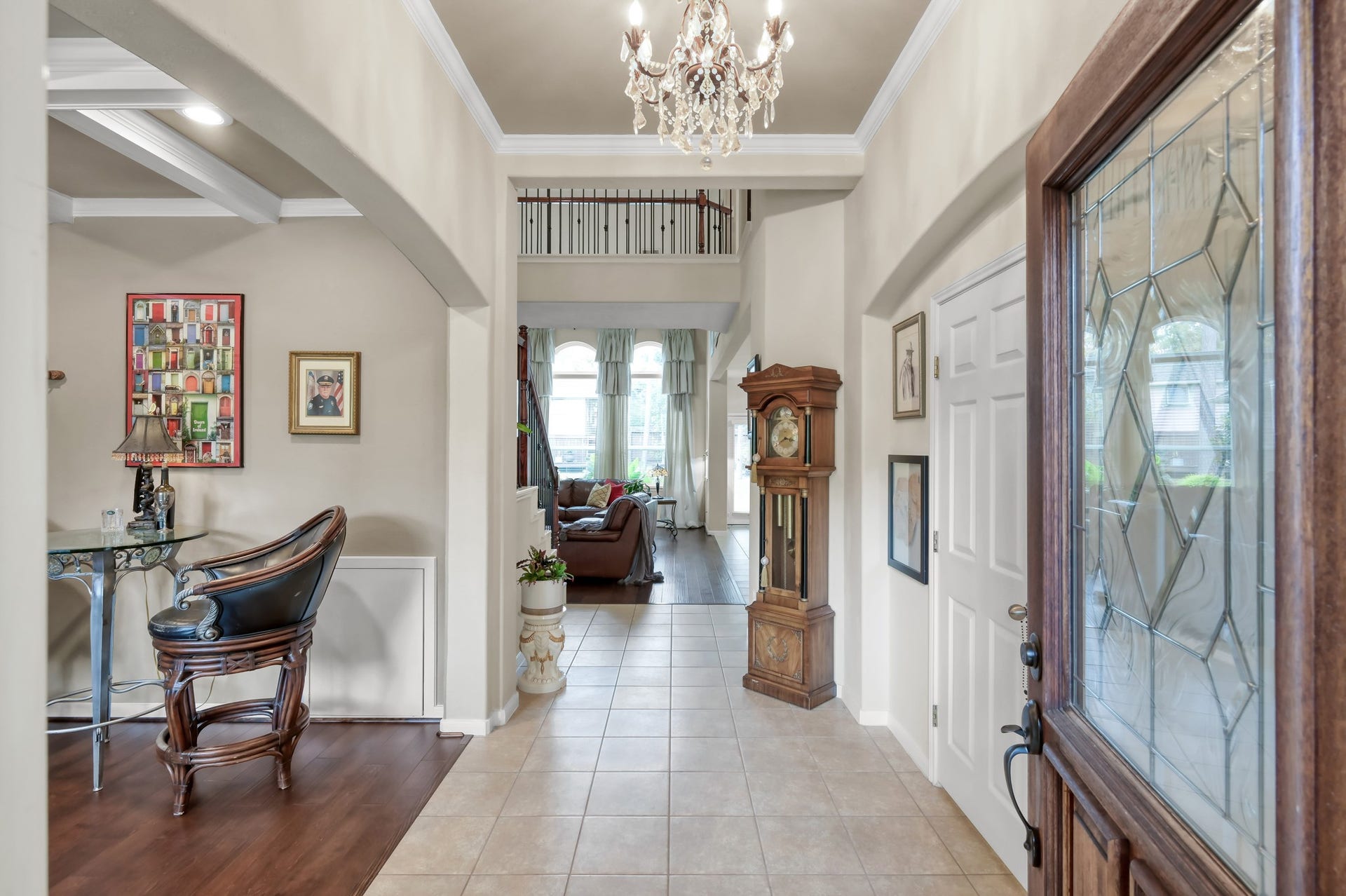 2502 Wynden Meadow Lane, Conroe, TX 77304 Step inside to soaring ceilings, elegant lighting, and an open, airy entryway that instantly feels welcoming. Natural light pours through the home, while the wood and tile flooring add warmth and style throughout.