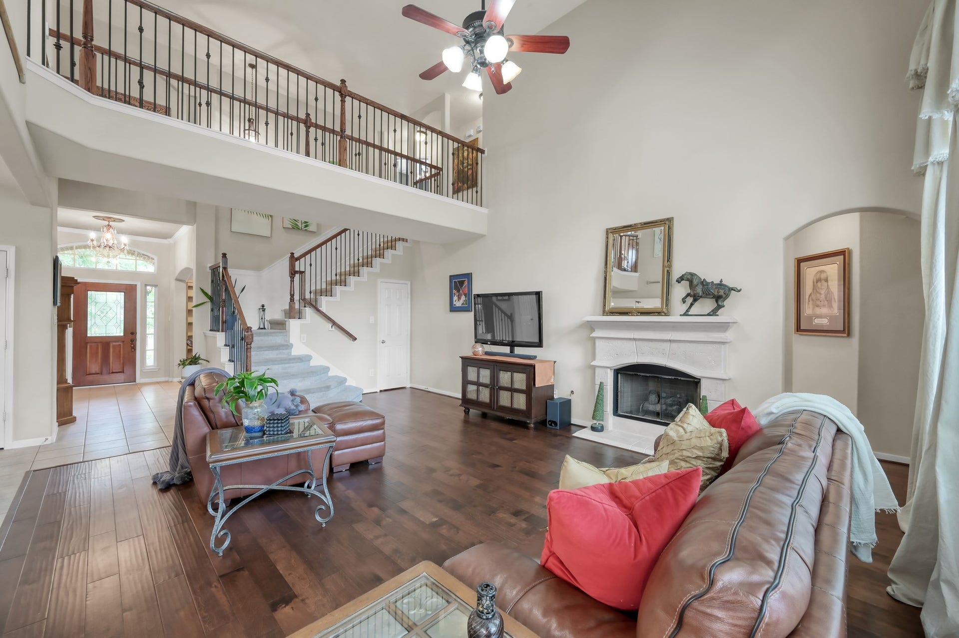 2502 Wynden Meadow Lane, Conroe, TX 77304 Relax in this warm and inviting livingroom complete with a cozy fireplace, gorgeous flooring, and expansive open views to the upstairs landing and entryway.