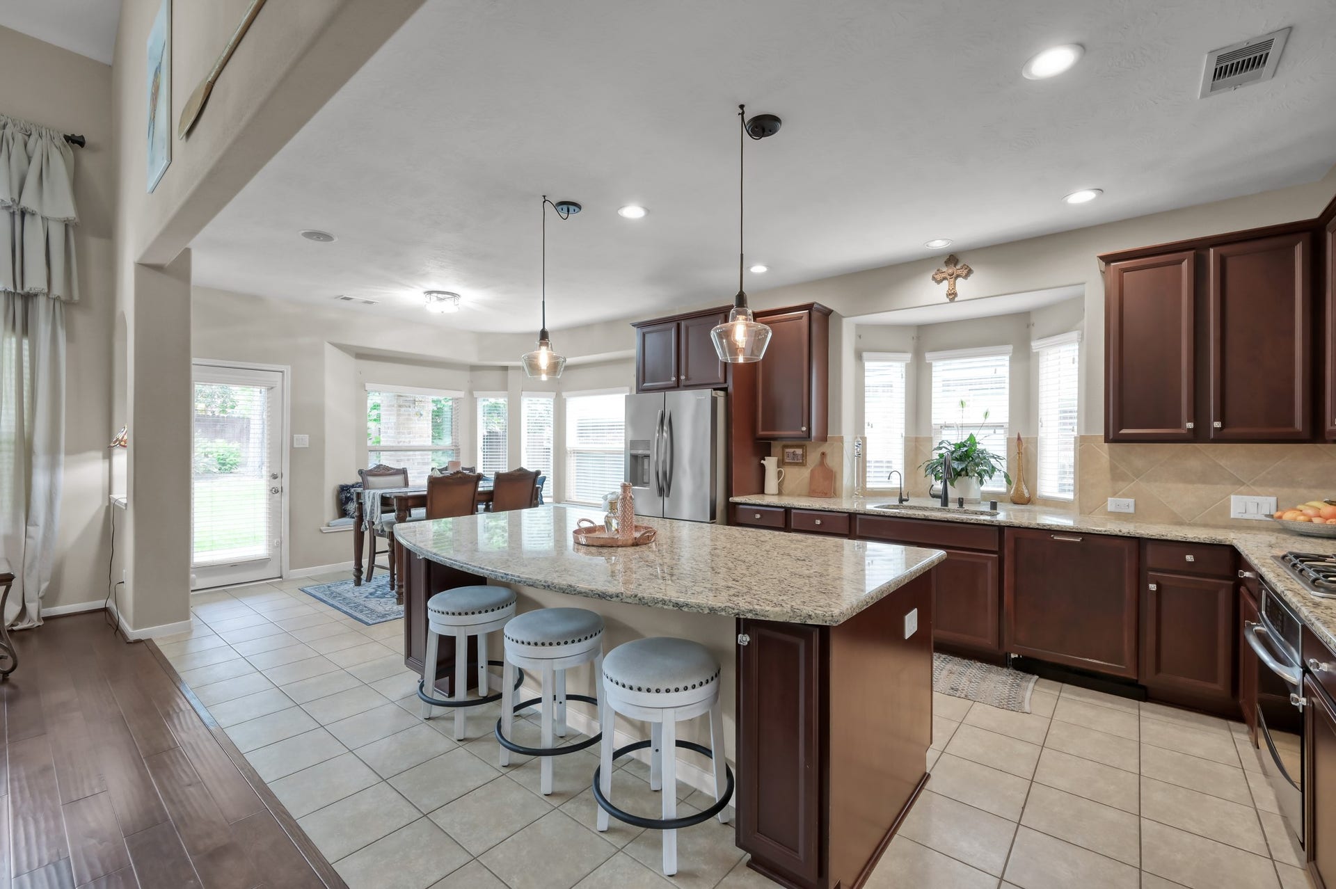 2502 Wynden Meadow Lane, Conroe, TX 77304 Bright breakfast nook with charming window seating and backyard views creates a cozy dining space filled with natural light. Easy access to the patio makes indoor/outdoor entertaining simple.