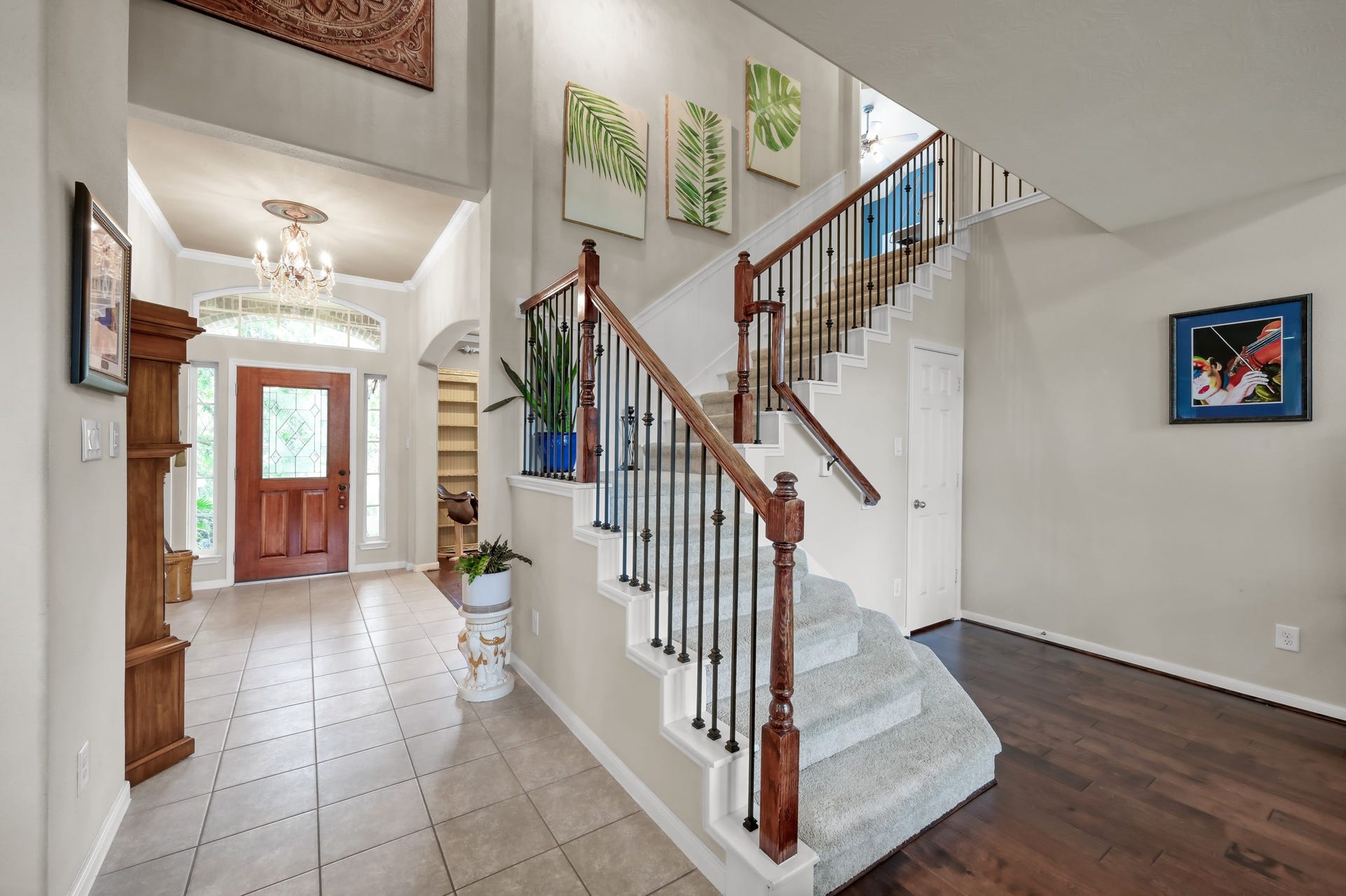 2502 Wynden Meadow Lane, Conroe, TX 77304 Beautiful staircase with wrought iron details and wood accents creates a grand focal point the moment you walk in. The open layout and soaring ceilings make the home feel bright and inviting.