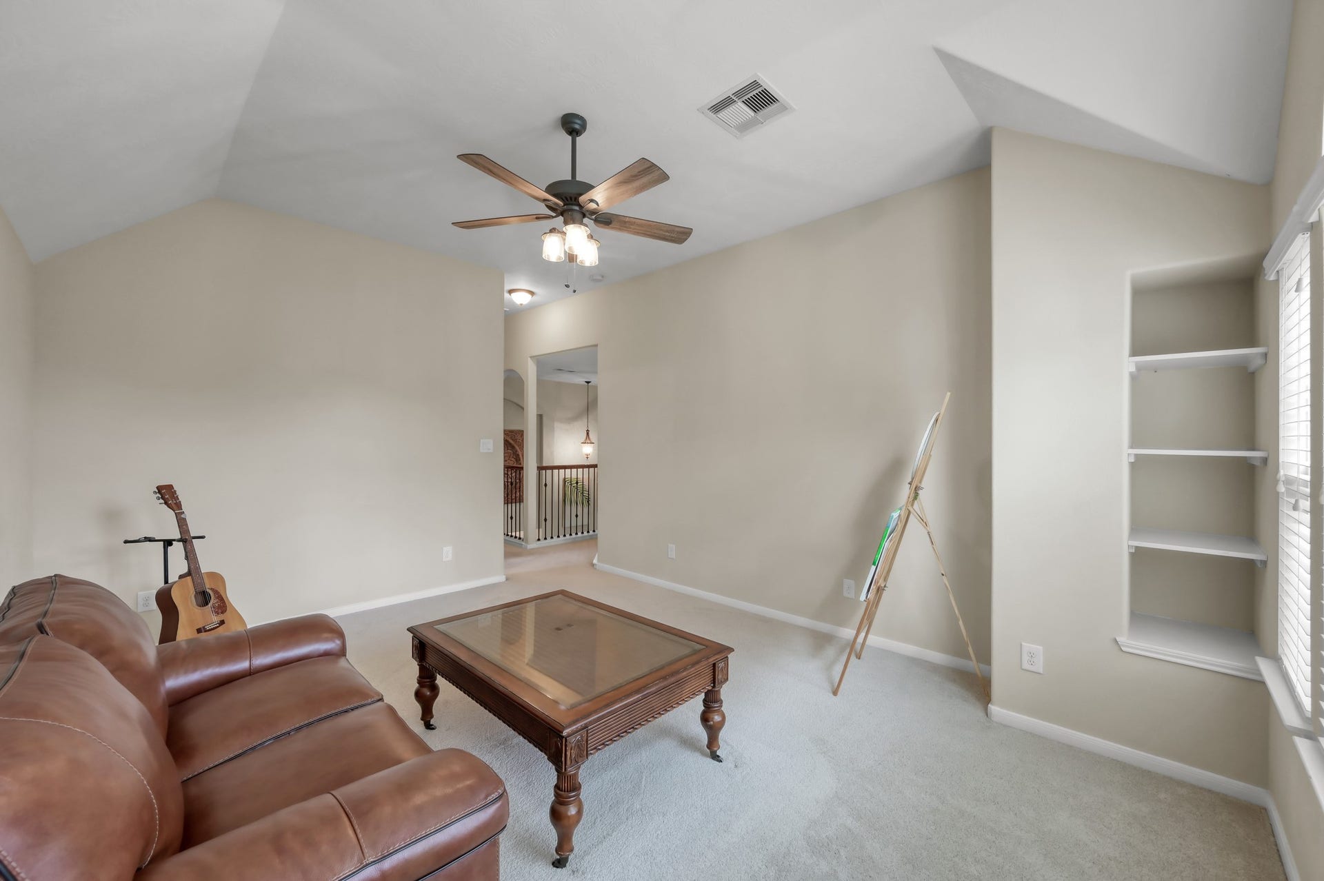 2502 Wynden Meadow Lane, Conroe, TX 77304 This room also offers built-in shelving and open space ideal for a playroom, hobby room, second office, or lounge area.