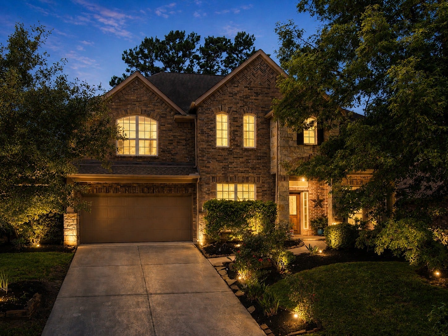 2502 Wynden Meadow Lane, Conroe, TX 77304 Beautifully maintained home with a private backyard retreat, covered patio, and inviting outdoor lighting. Warm interior glow and lush landscaping create the perfect setting for relaxing evenings and entertaining guests.