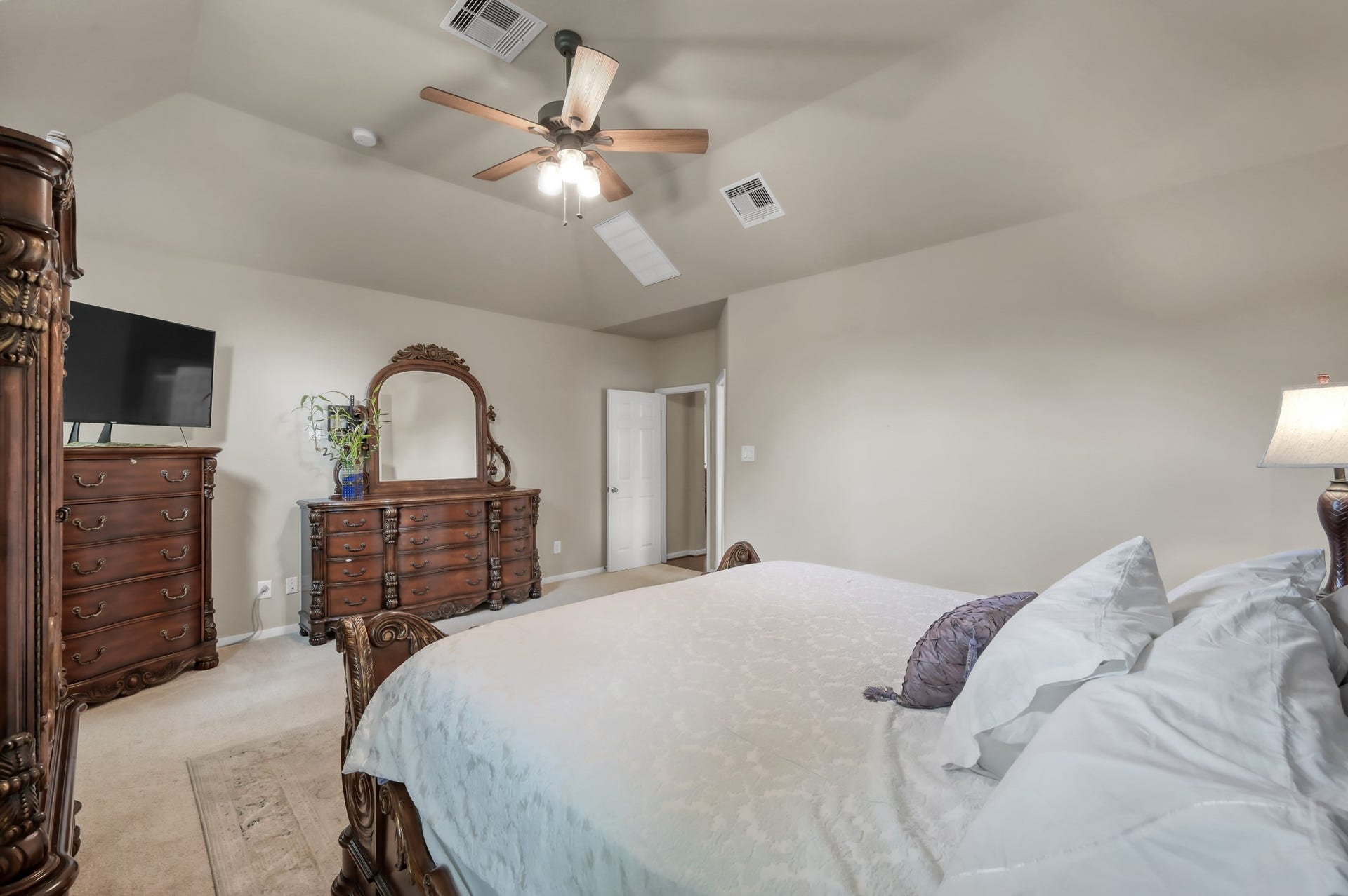 2502 Wynden Meadow Lane, Conroe, TX 77304 Spacious primary suite with high ceilings, neutral tones, and plenty of room for oversized furniture. A peaceful retreat with soft natural light and a comfortable, relaxing feel.