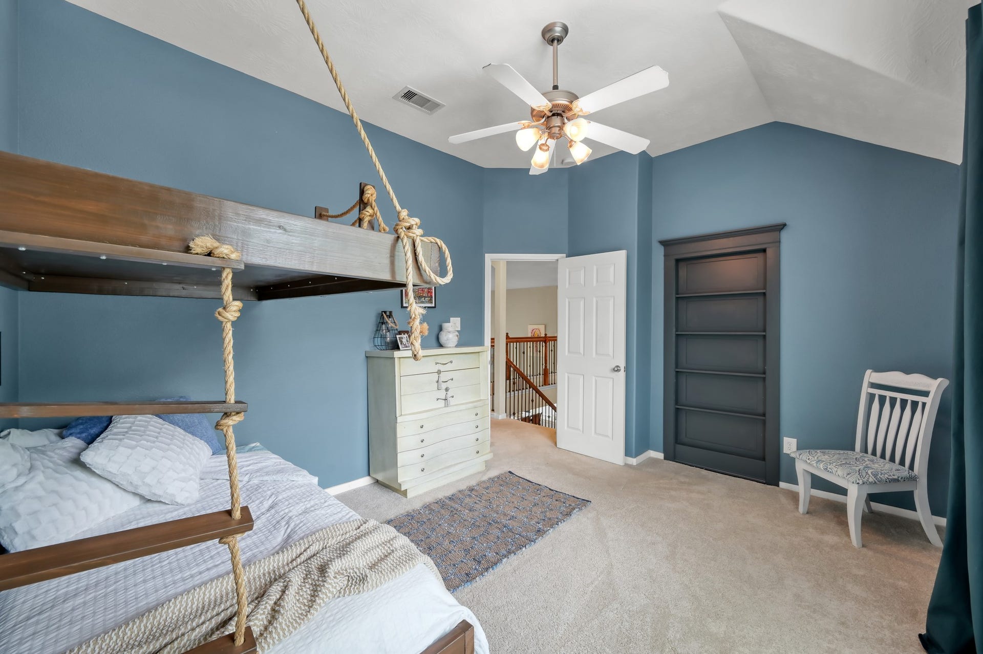 2502 Wynden Meadow Lane, Conroe, TX 77304 Fun and stylish bedroom with soaring ceilings, custom rope-style bunk beds, built-in shelving, and plenty of room to personalize the space.