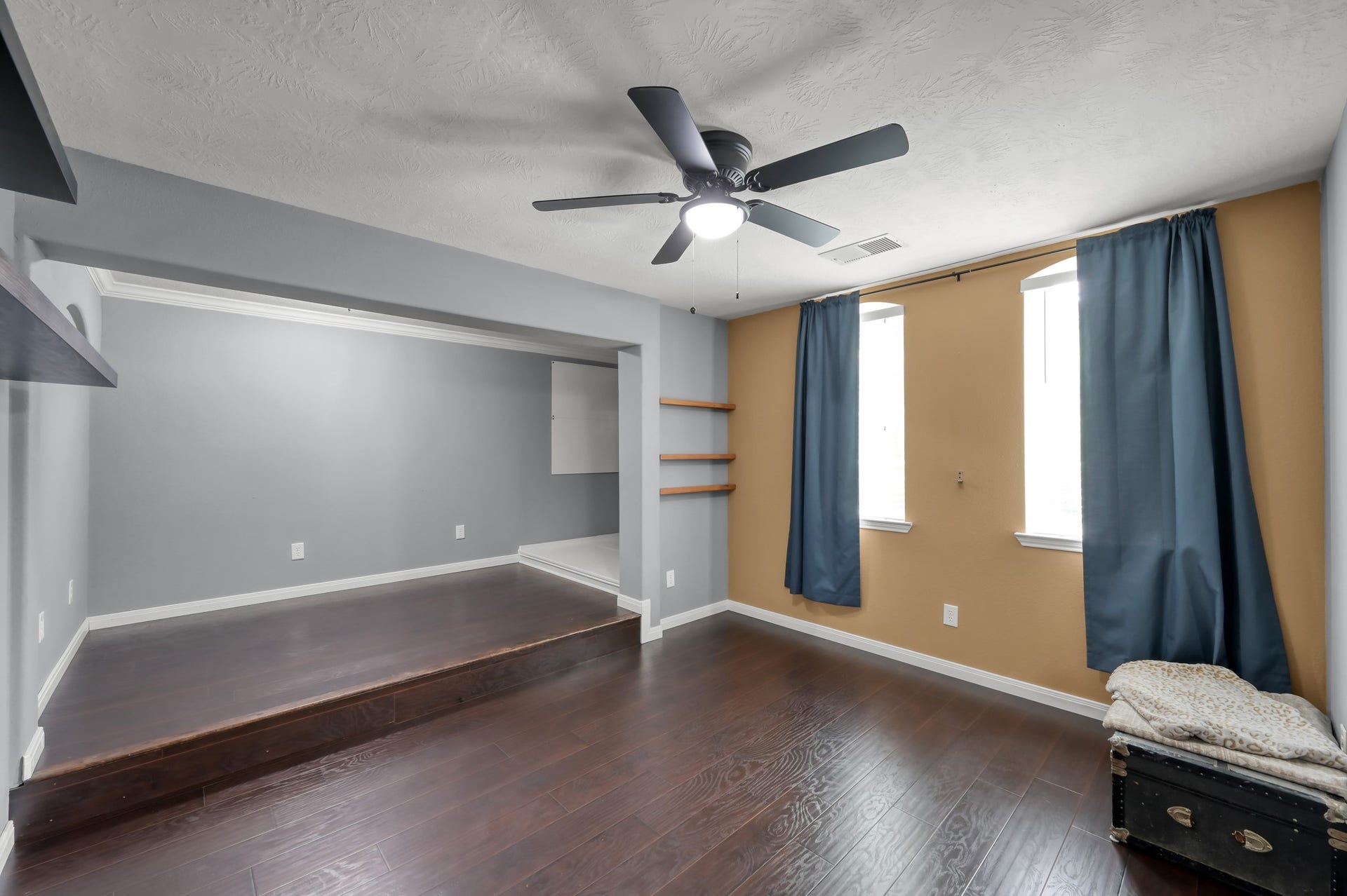 2502 Wynden Meadow Lane, Conroe, TX 77304 Enormous secret room with rich wood flooring and elevated platform area, offering endless possibilities for a studio, workout space, game room, or creative retreat.